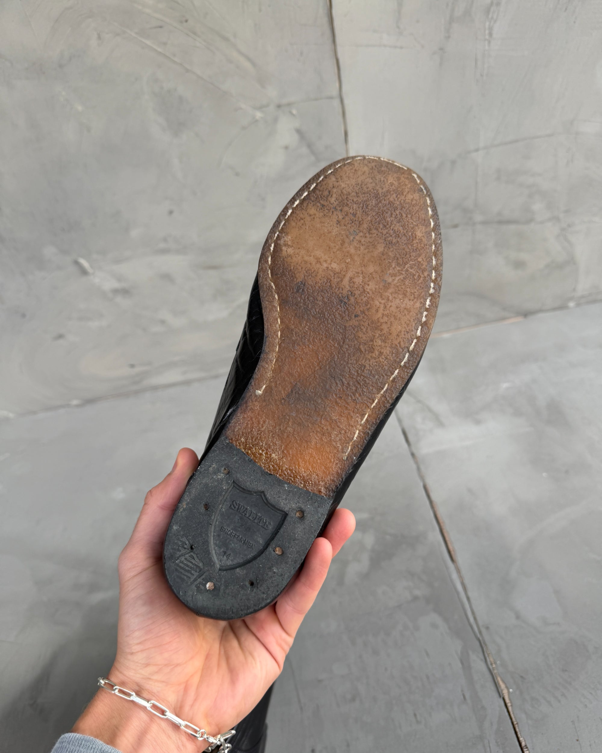 Yves Saint Laurent Black Leather Loafers – UK 8-on a concrete background