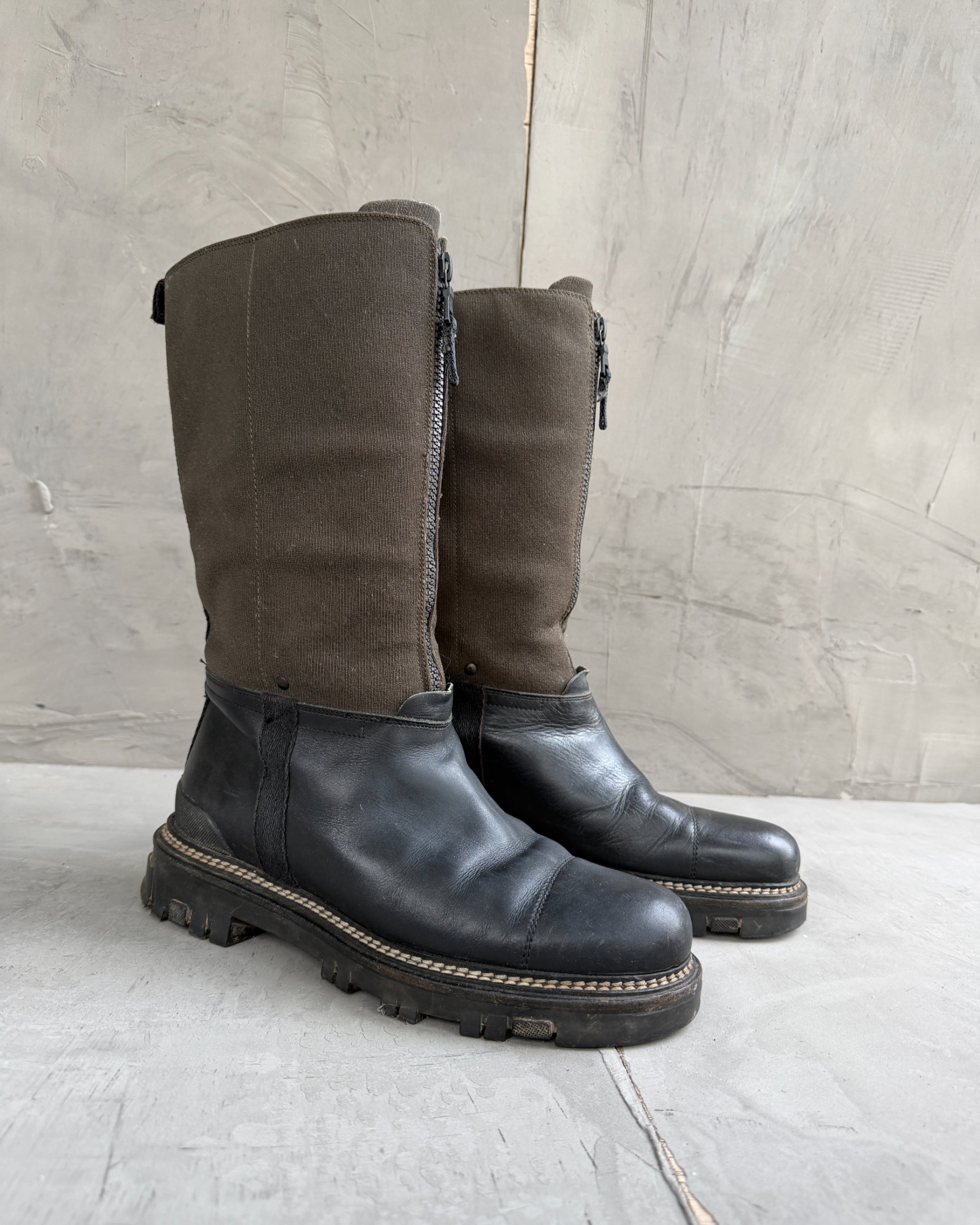Prada Lug Sole Leather and Neoprene Boots – EU 38-on a concrete background