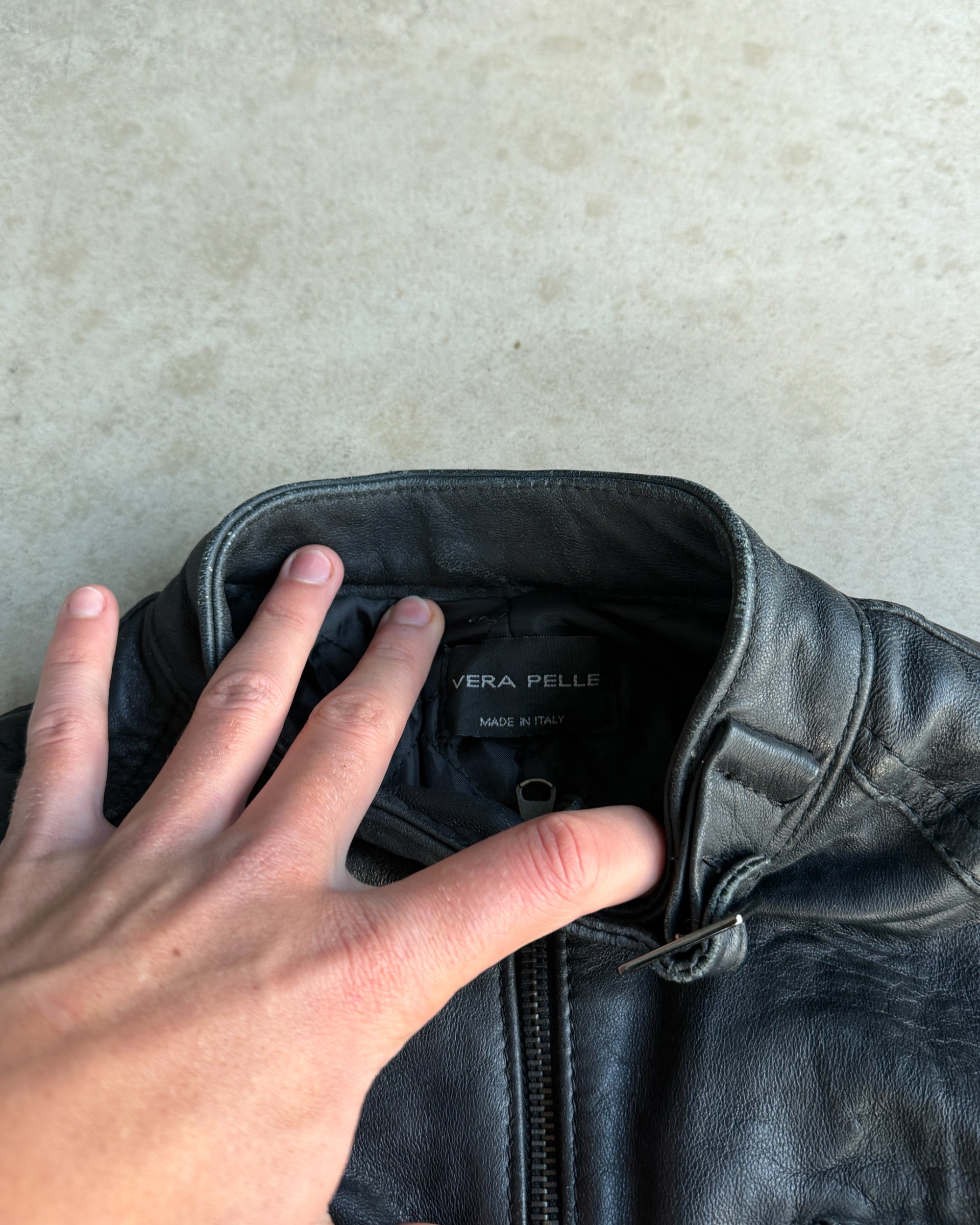 Italian Black Leather Multi-Pocket Jacket – S-on a concrete background