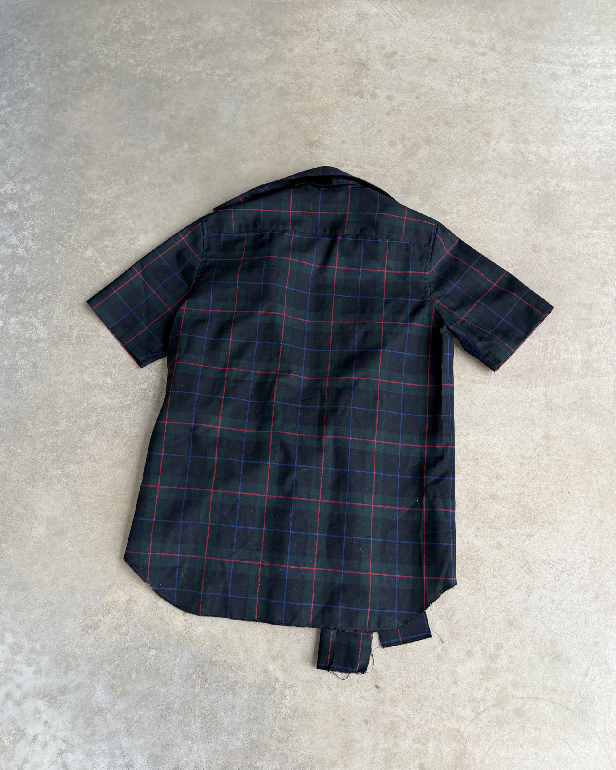Comme des Garçons Tricot AW04 Checkered Short Sleeve Shirt – M-on a concrete background