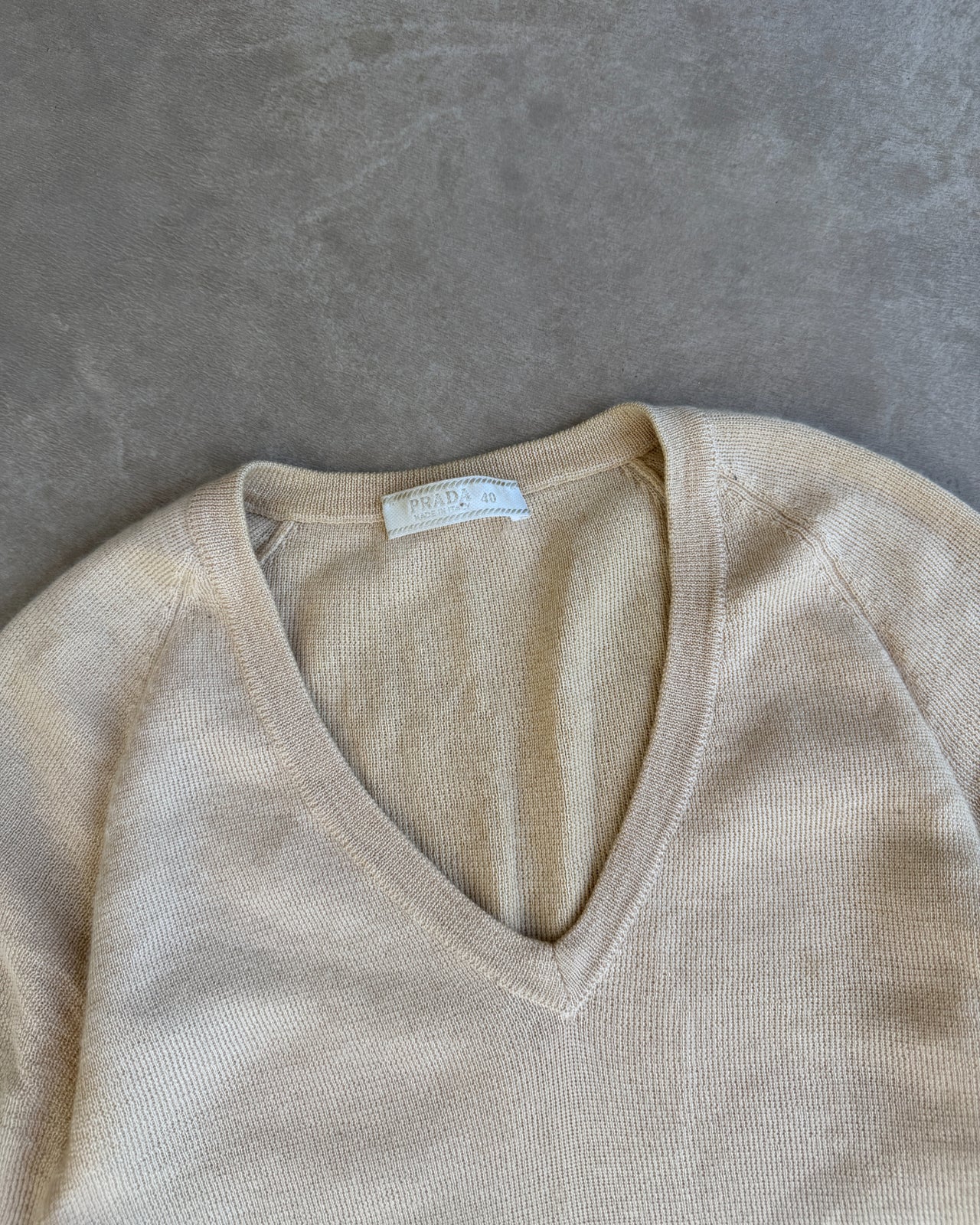 Prada Cashmere Silk Blend V Neck T-Shirt – S-on a concrete background
