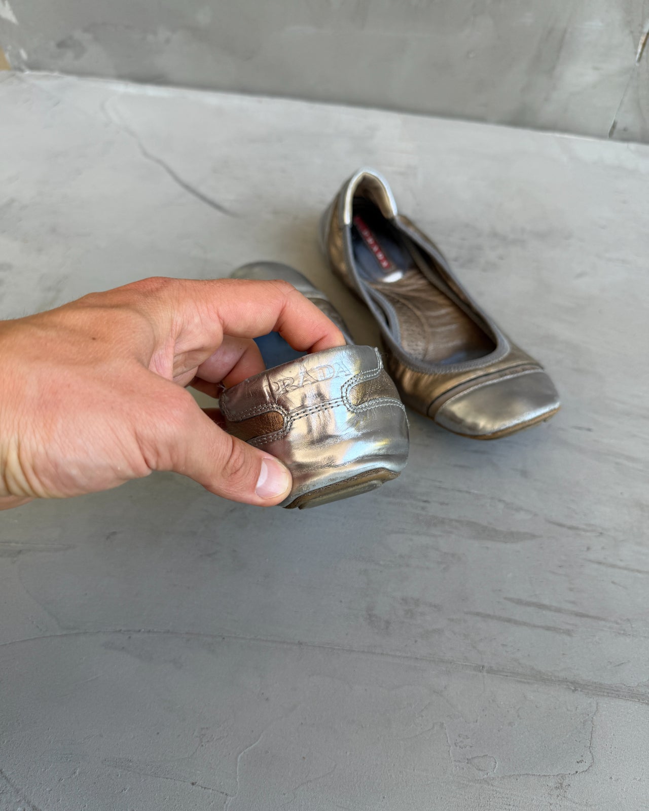 Prada White Gold and Silver Ballet Flat – EU 37-on a concrete background