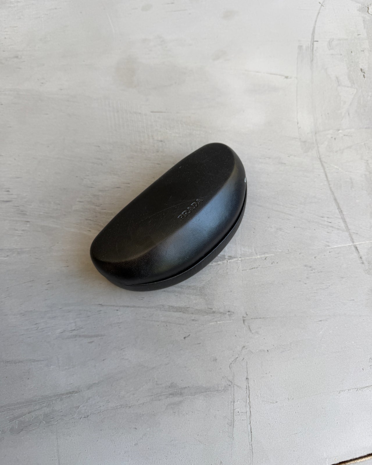 Prada Brown Sunglasses-on a concrete background