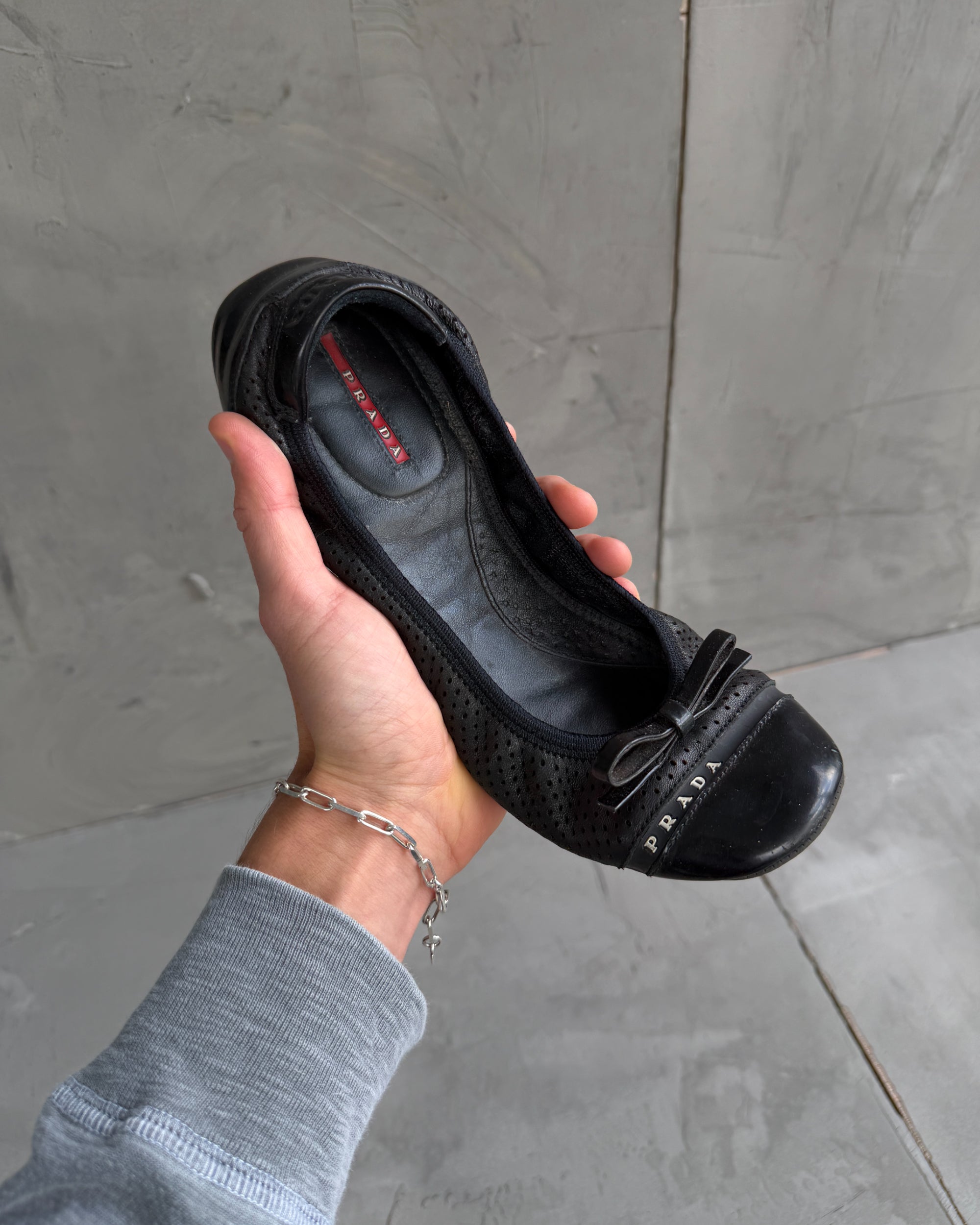 Prada Black Ballet Flats – EU 39-on a concrete background