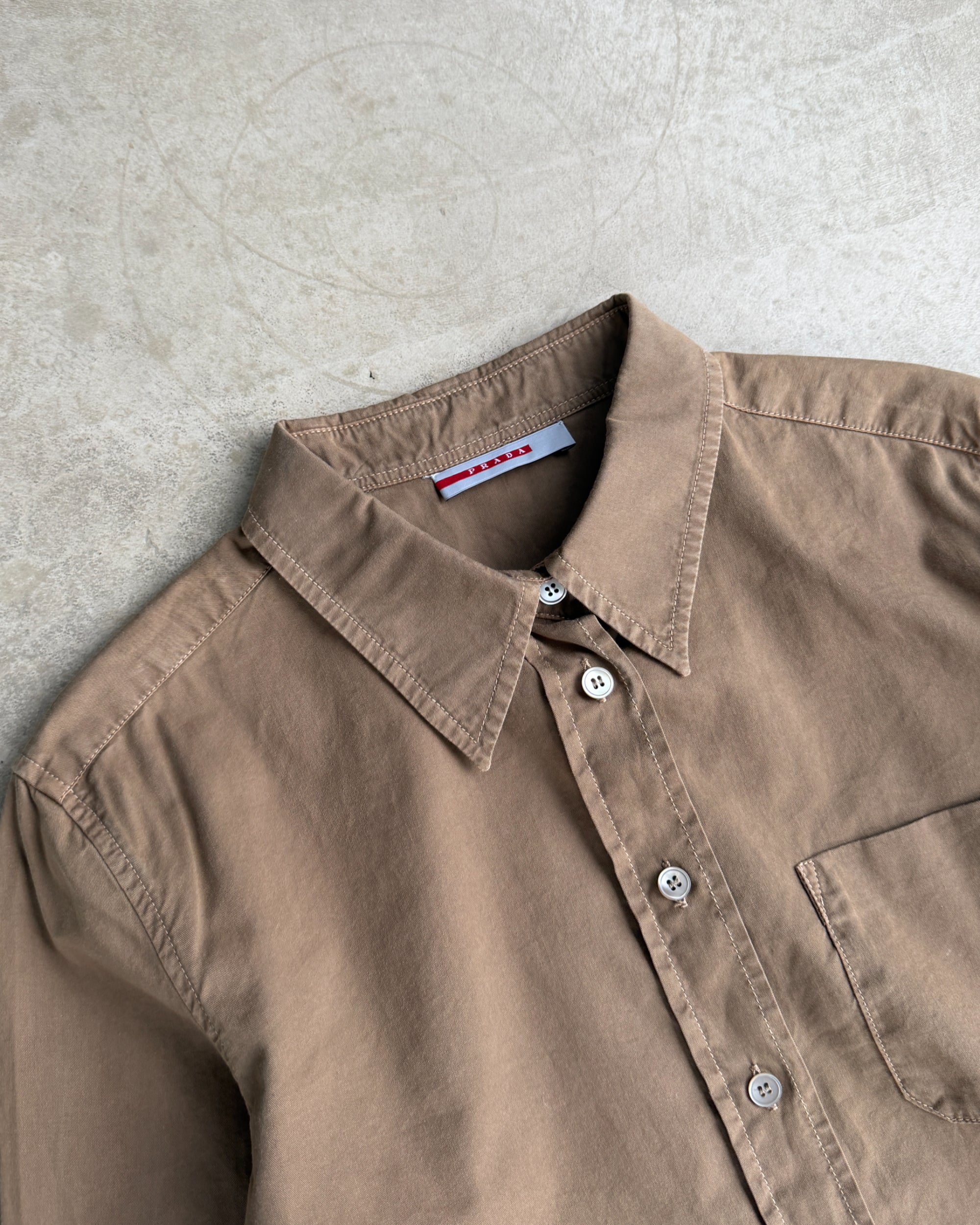 Prada Brown Cotton Shirt – S-on a concrete background
