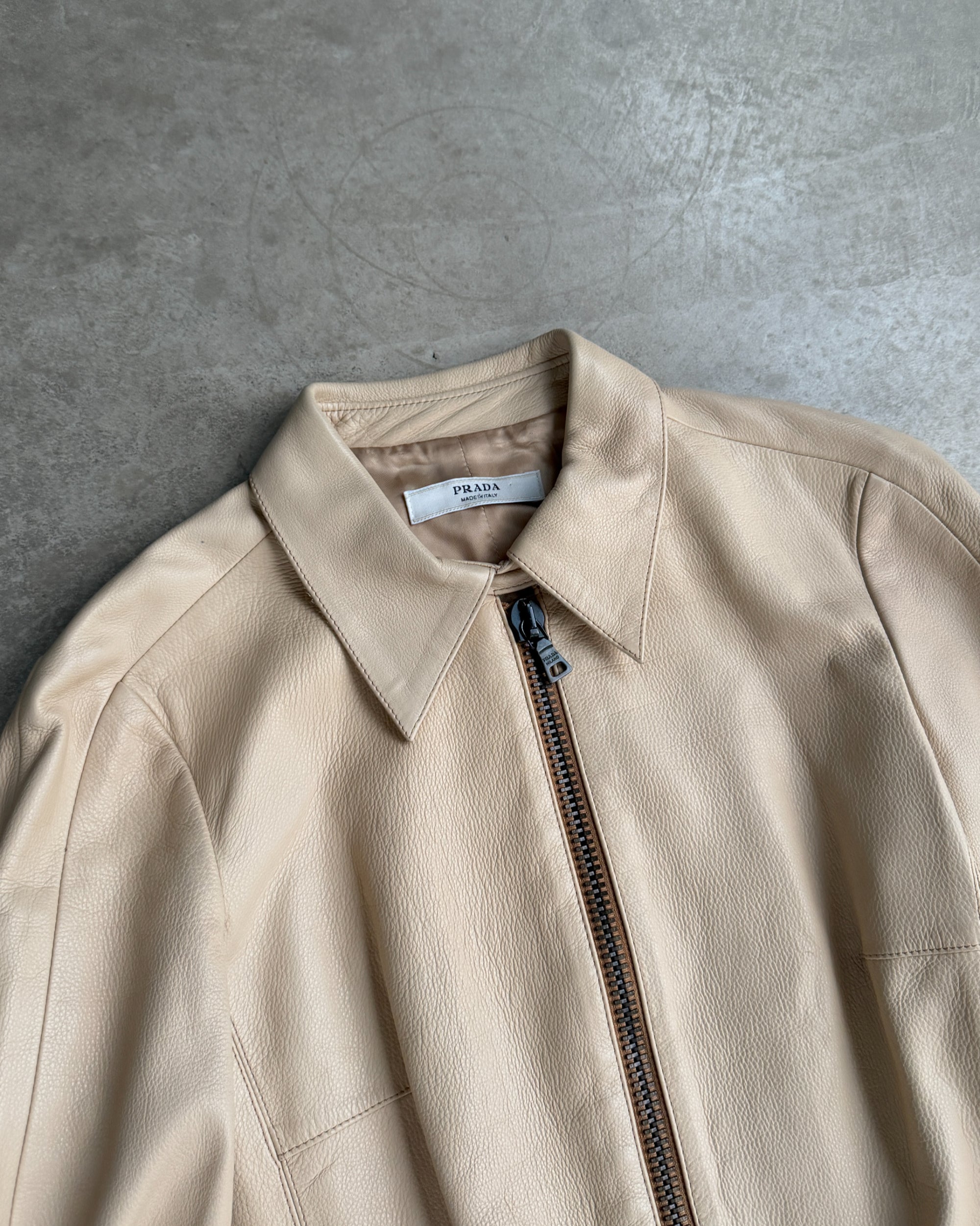 Prada Beige Leather Belted Jacket – M-on a concrete background