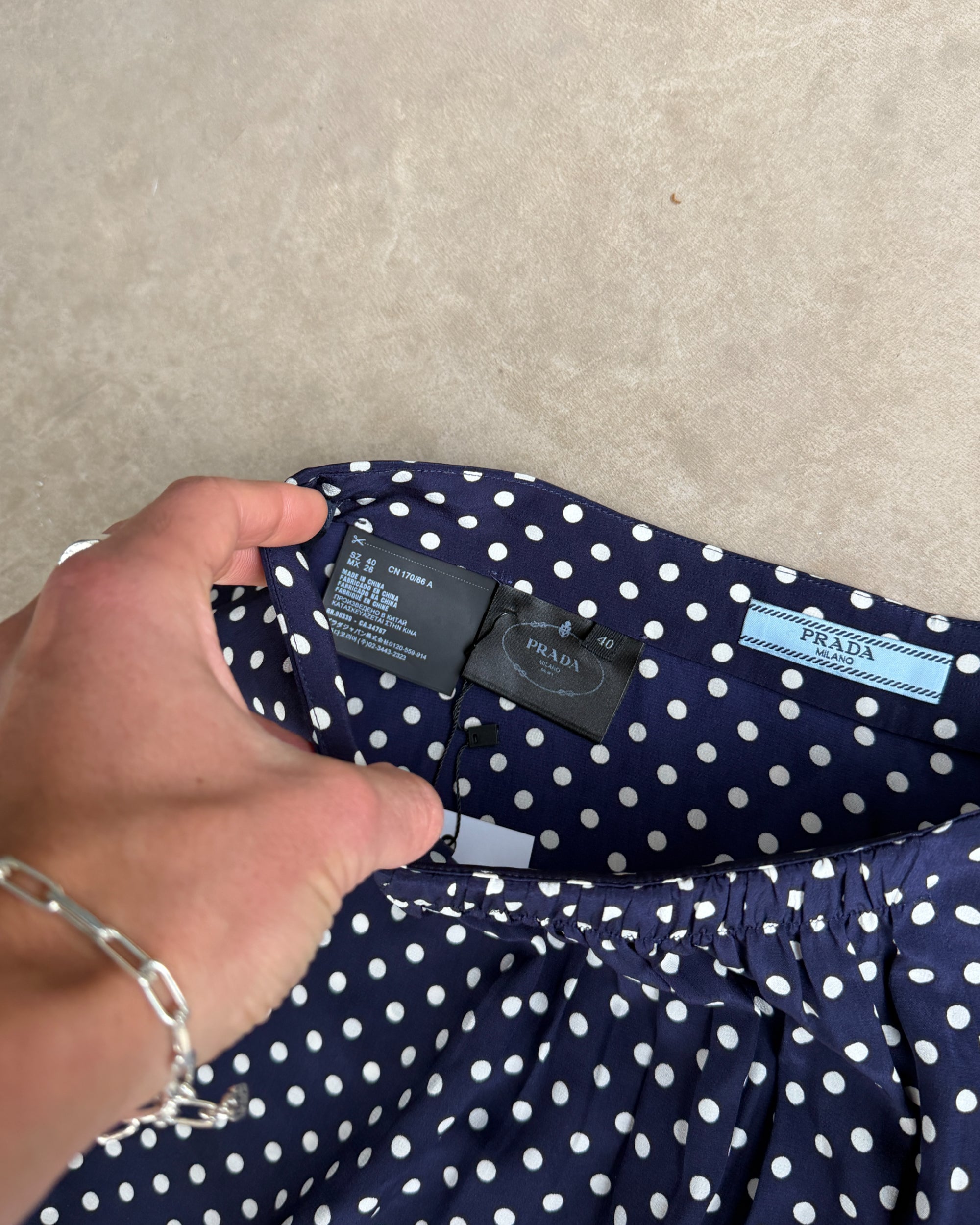 Prada Blue Polka Dot Silk Midi Skirt – S-on a concrete background