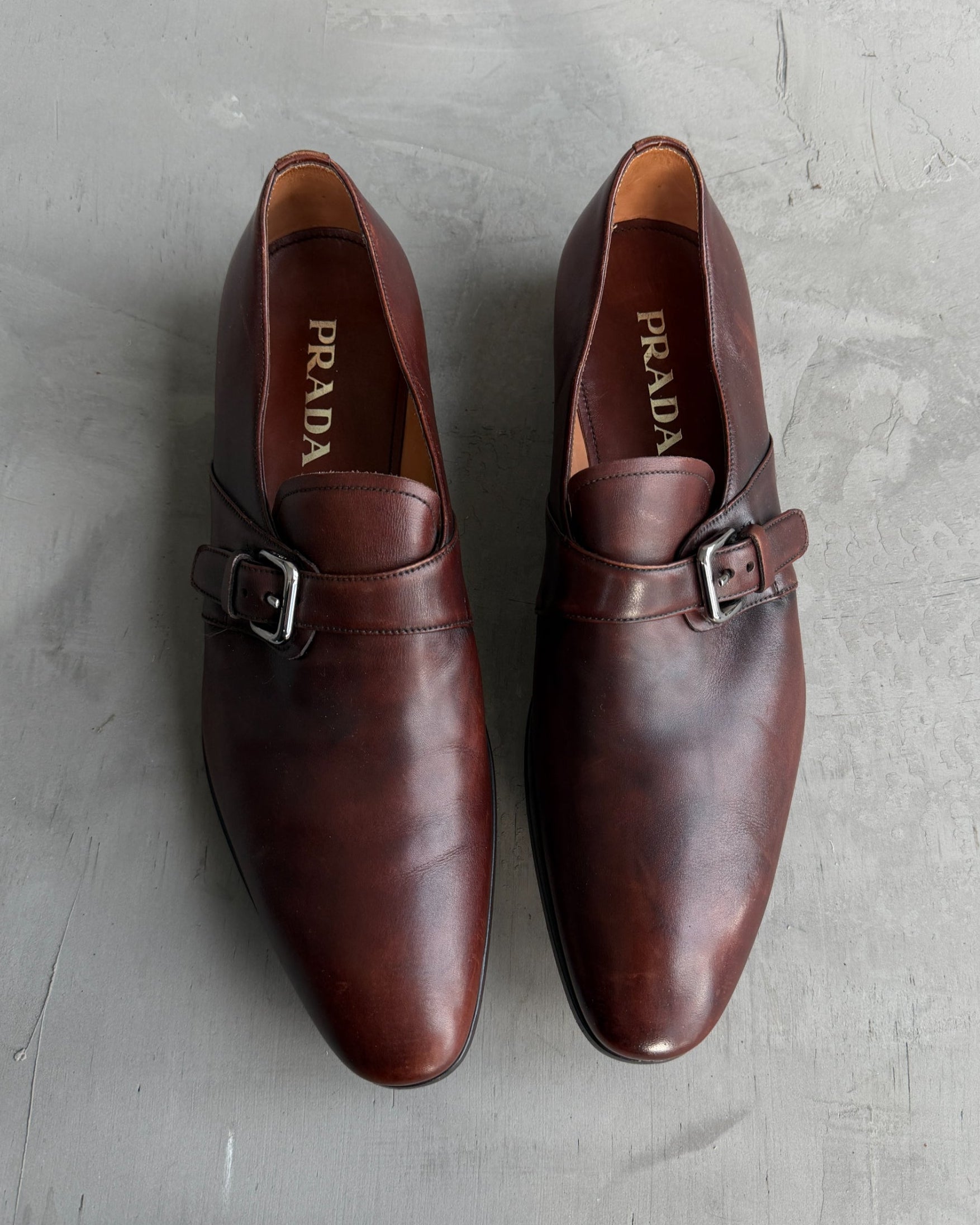 Prada Buckle Leather Derbys – UK 9-on a concrete background