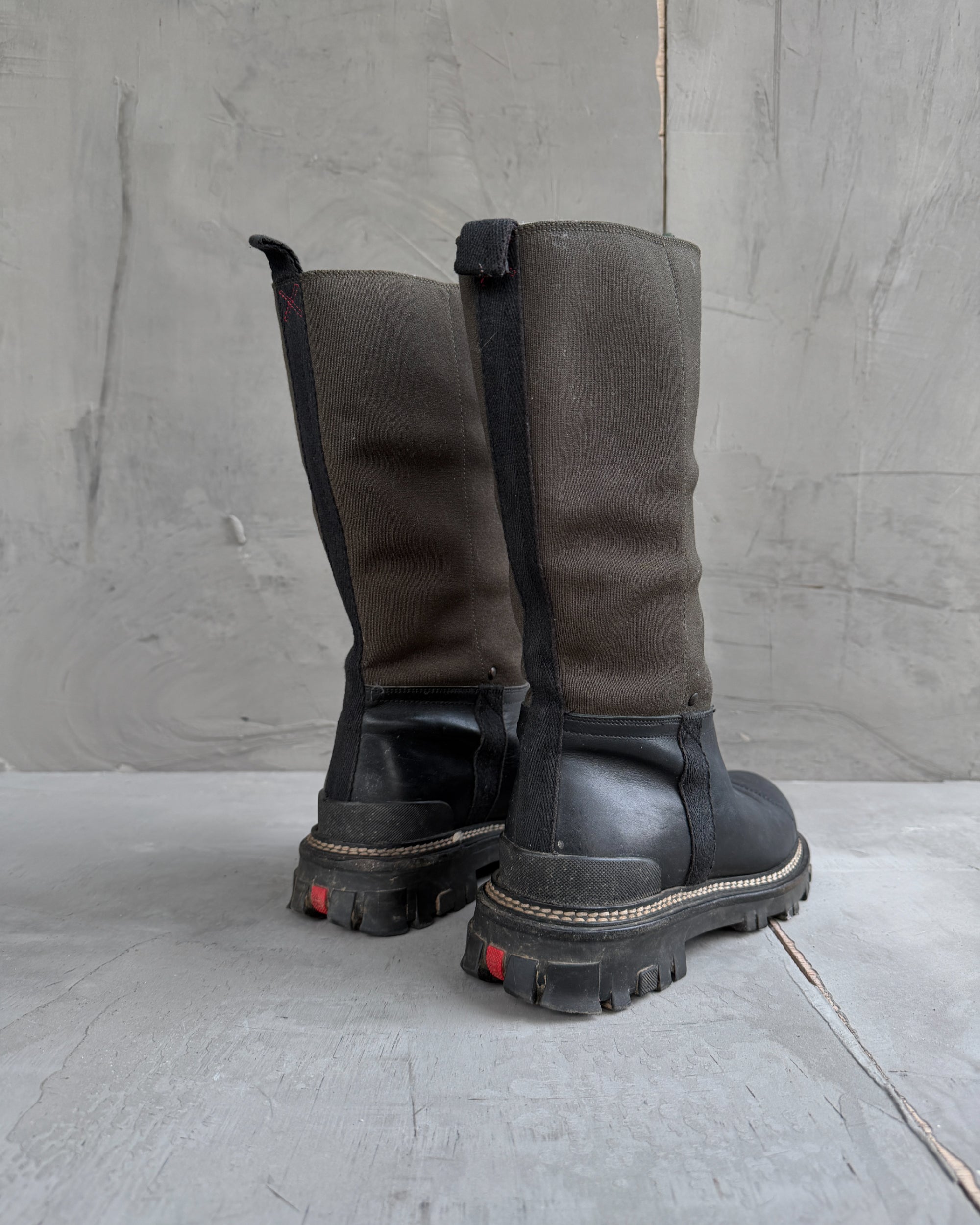 Prada Lug Sole Leather and Neoprene Boots – EU 38-on a concrete background