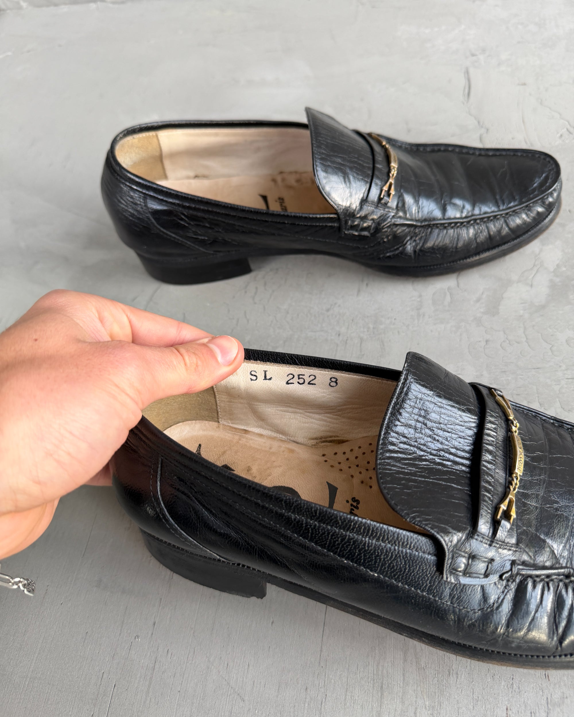 Yves Saint Laurent Black Leather Loafers – UK 8-on a concrete background