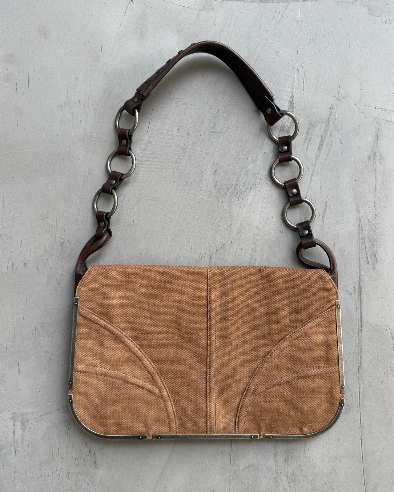 Yves Saint Laurent Brown Canvas Shoulder Bag-on a concrete background
