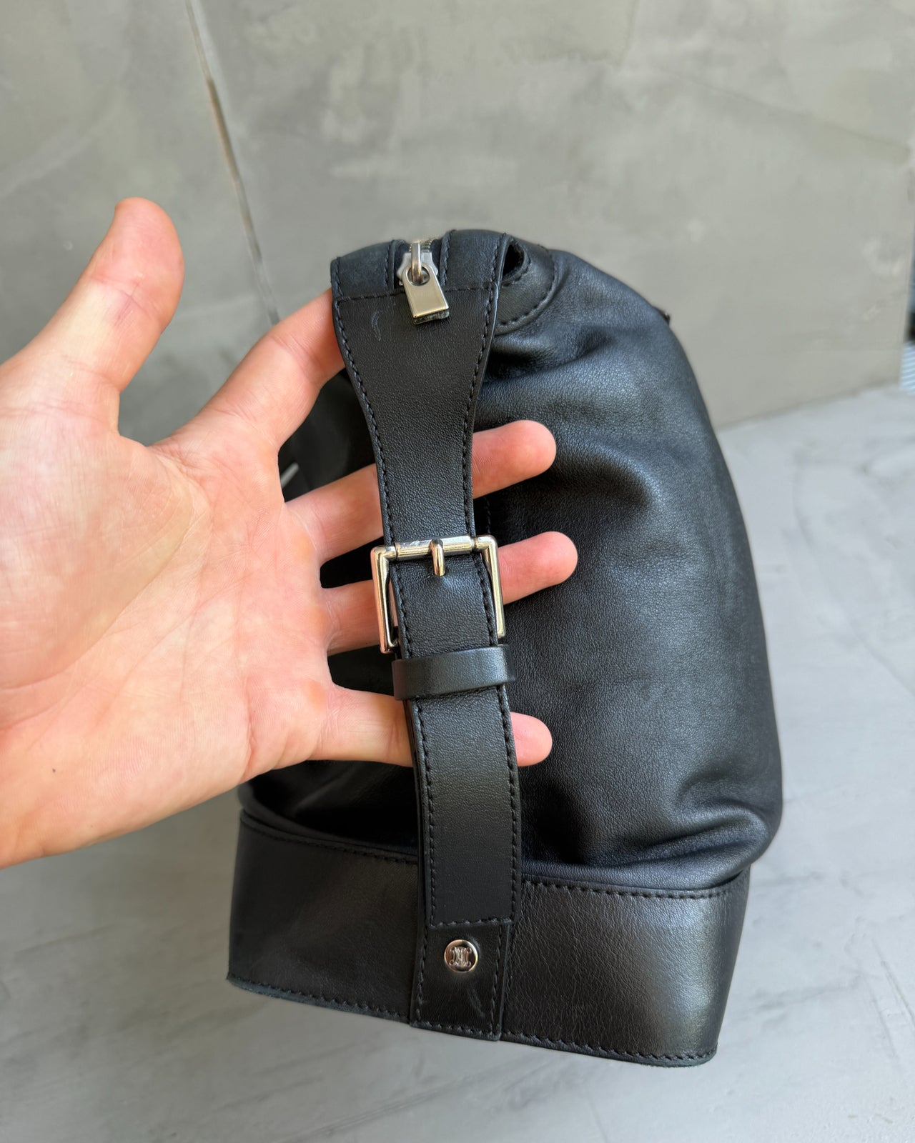 Celine Black Leather Handbag-on a concrete background