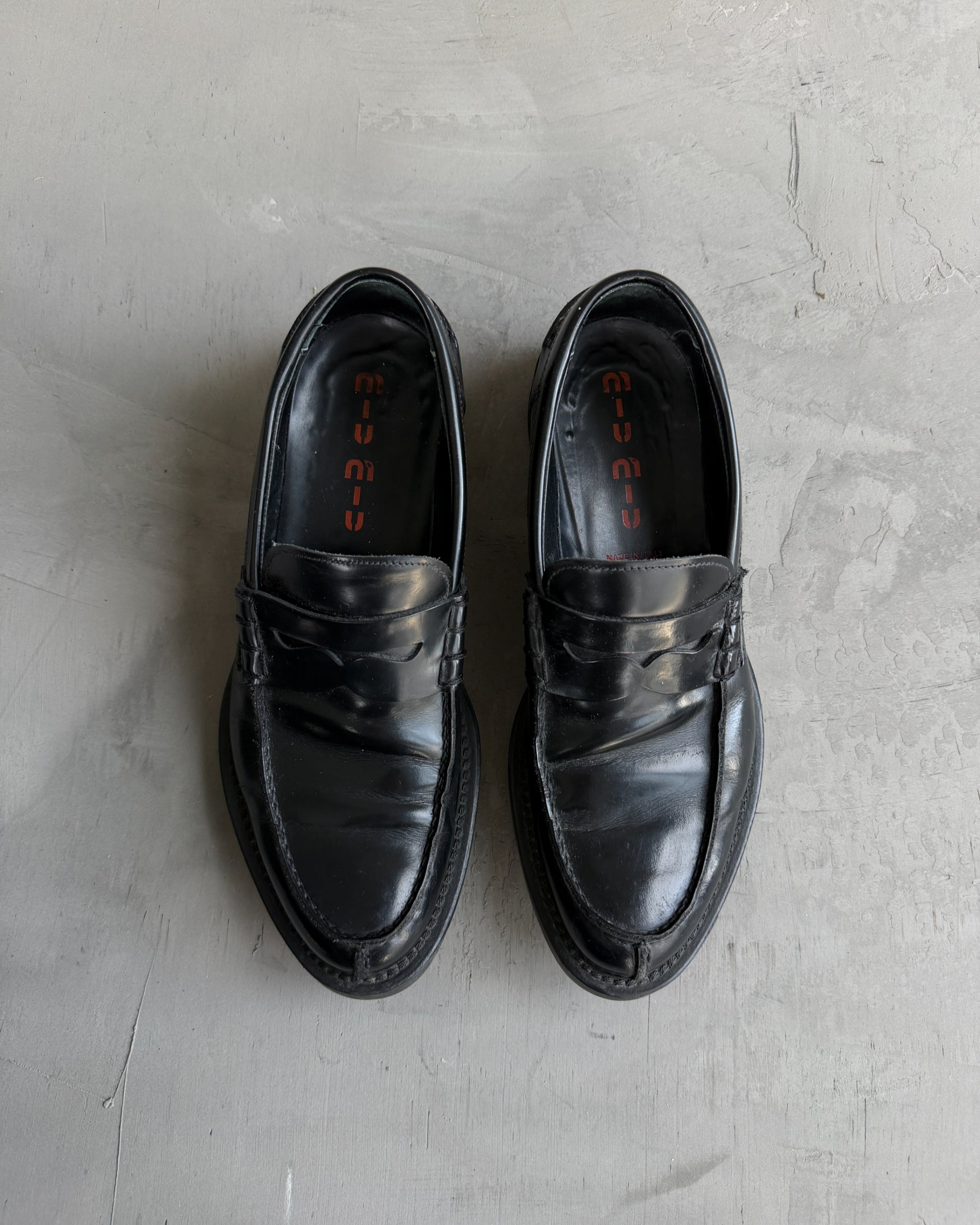 Miu Miu Black Leather Loafers – EU 40-on a concrete background