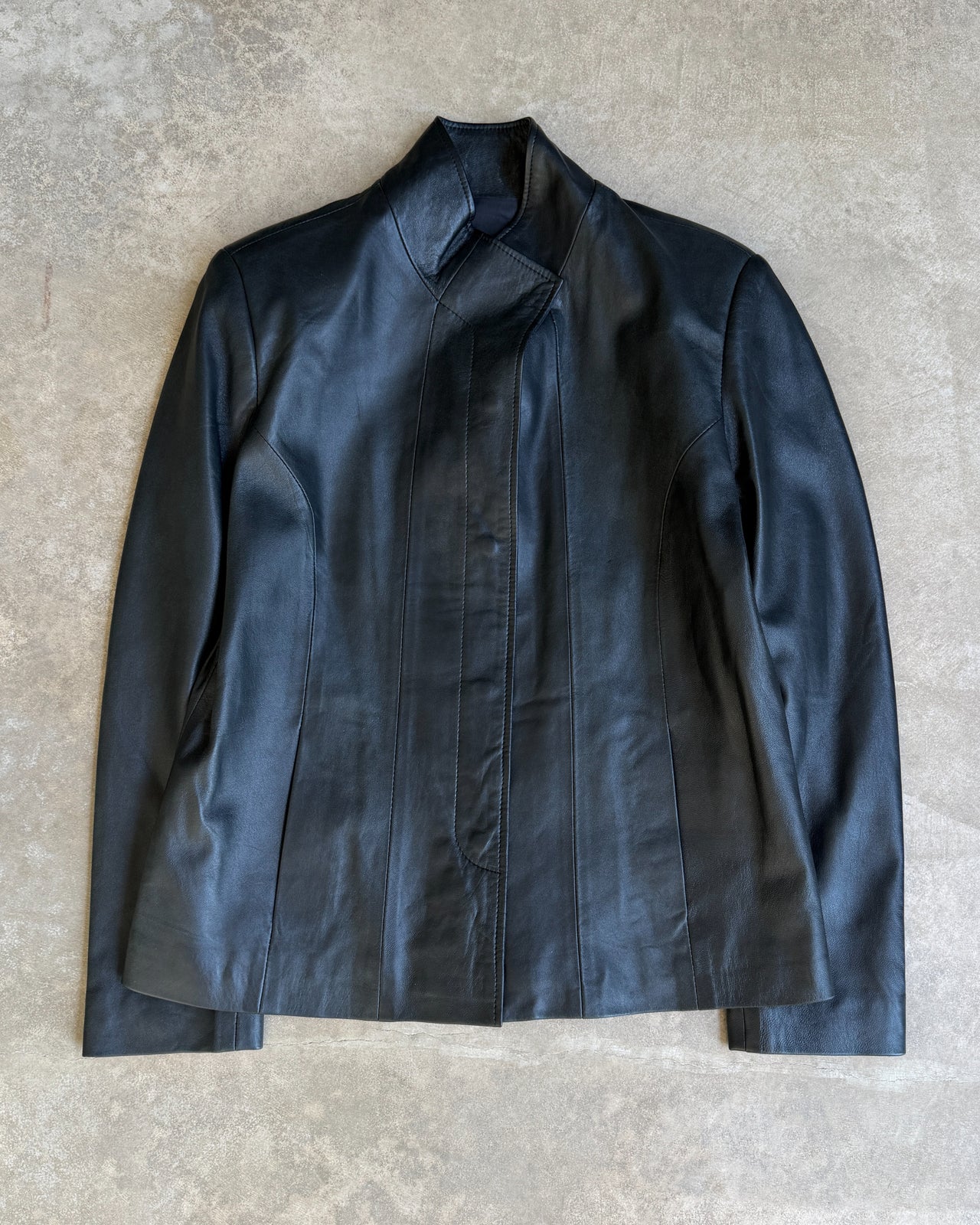 Unbranded Sample Black Leather Jacket – S/M-on a concrete background