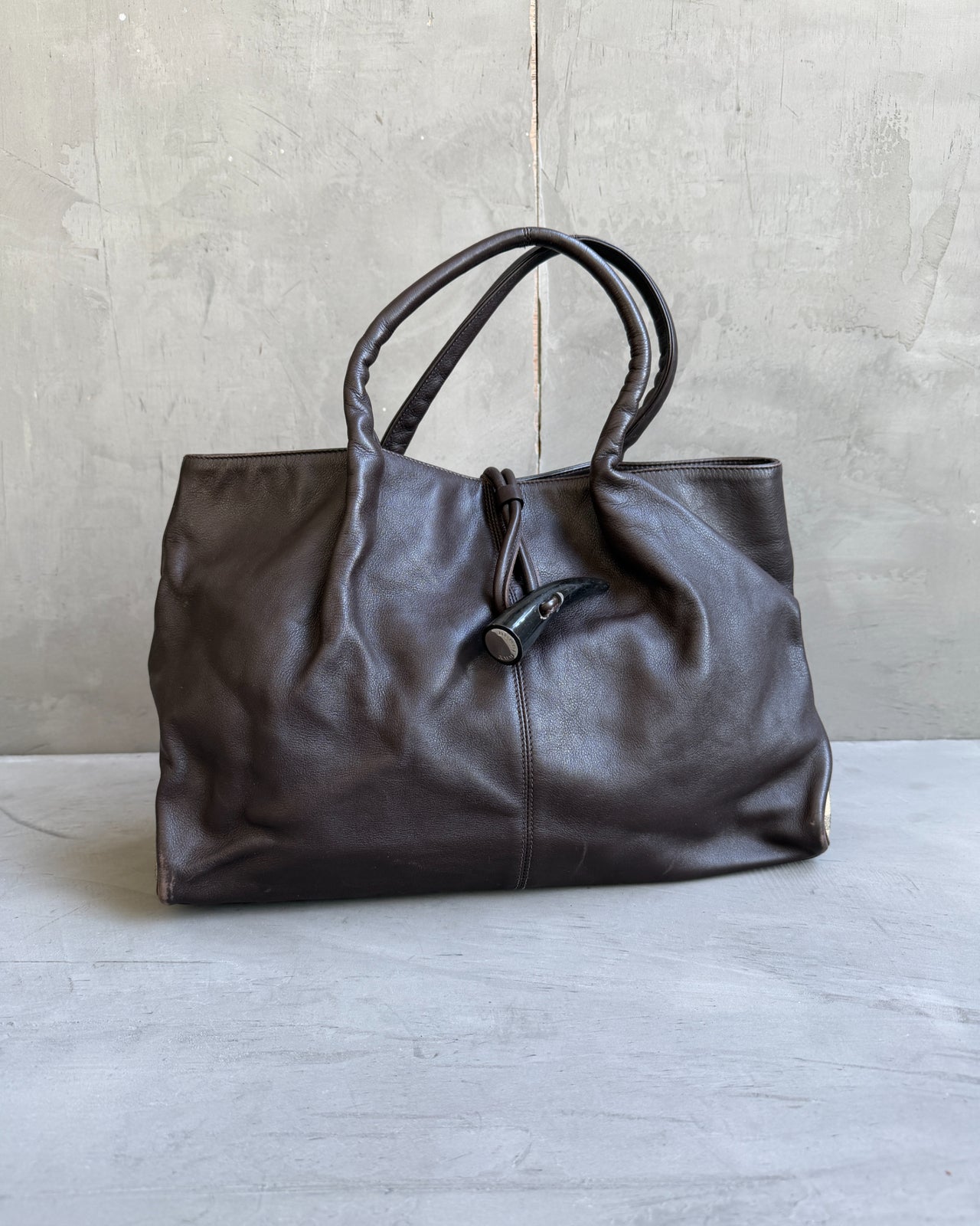 Burberry Dark Brown Leather Handbag-on a concrete background