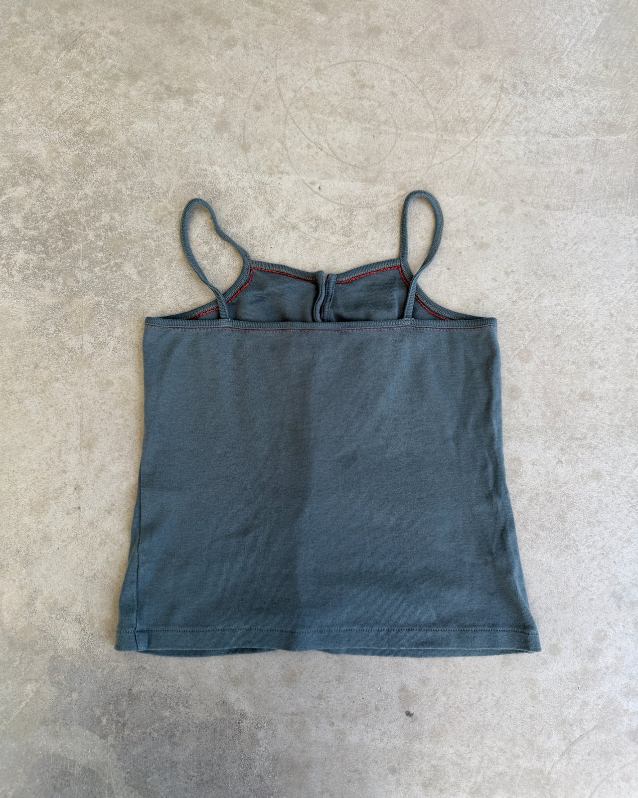 CFK Button Up Vest Top – XS/S-on a concrete background