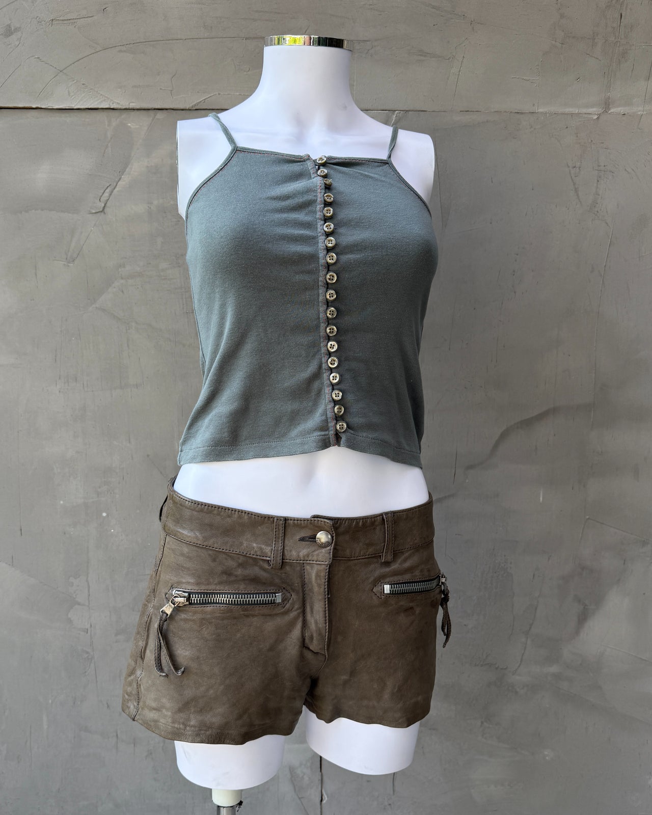 CFK Button Up Vest Top – XS/S-on a concrete background