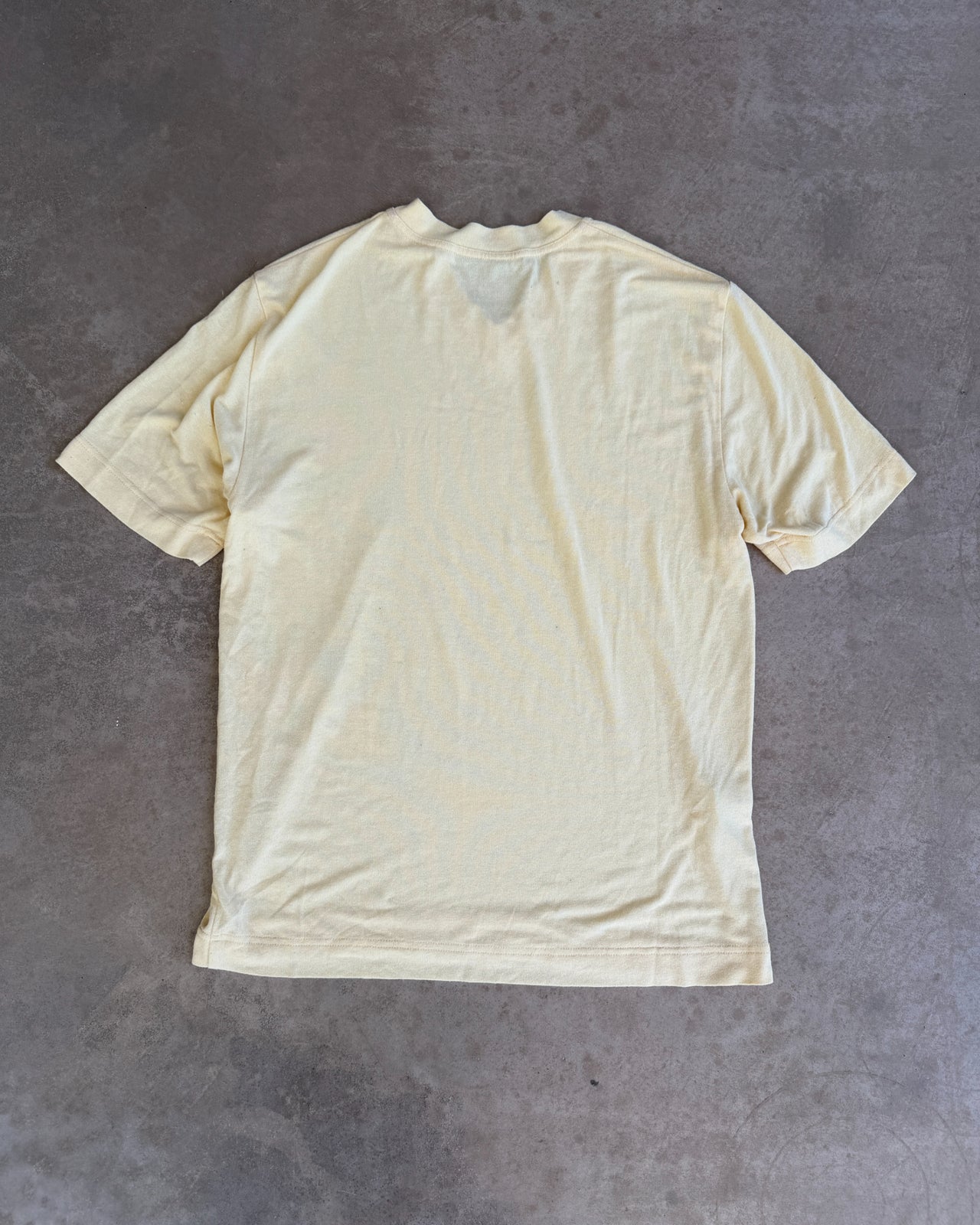 Dolce & Gabbana Yellow Viscose Semi Sheer V Neck T-Shirt – L-on a concrete background