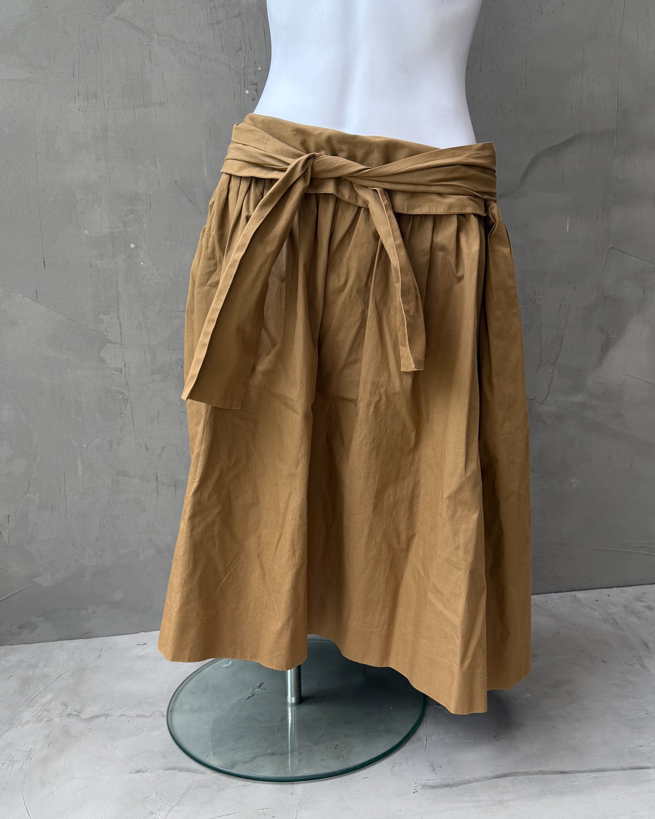 Chloé Cotton Wrap Tie Waist Midi Skirt-on a concrete background