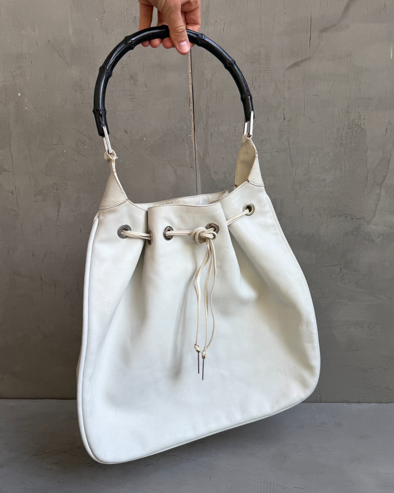 Gucci by Tom Ford White Leather Bag-on a concrete background
