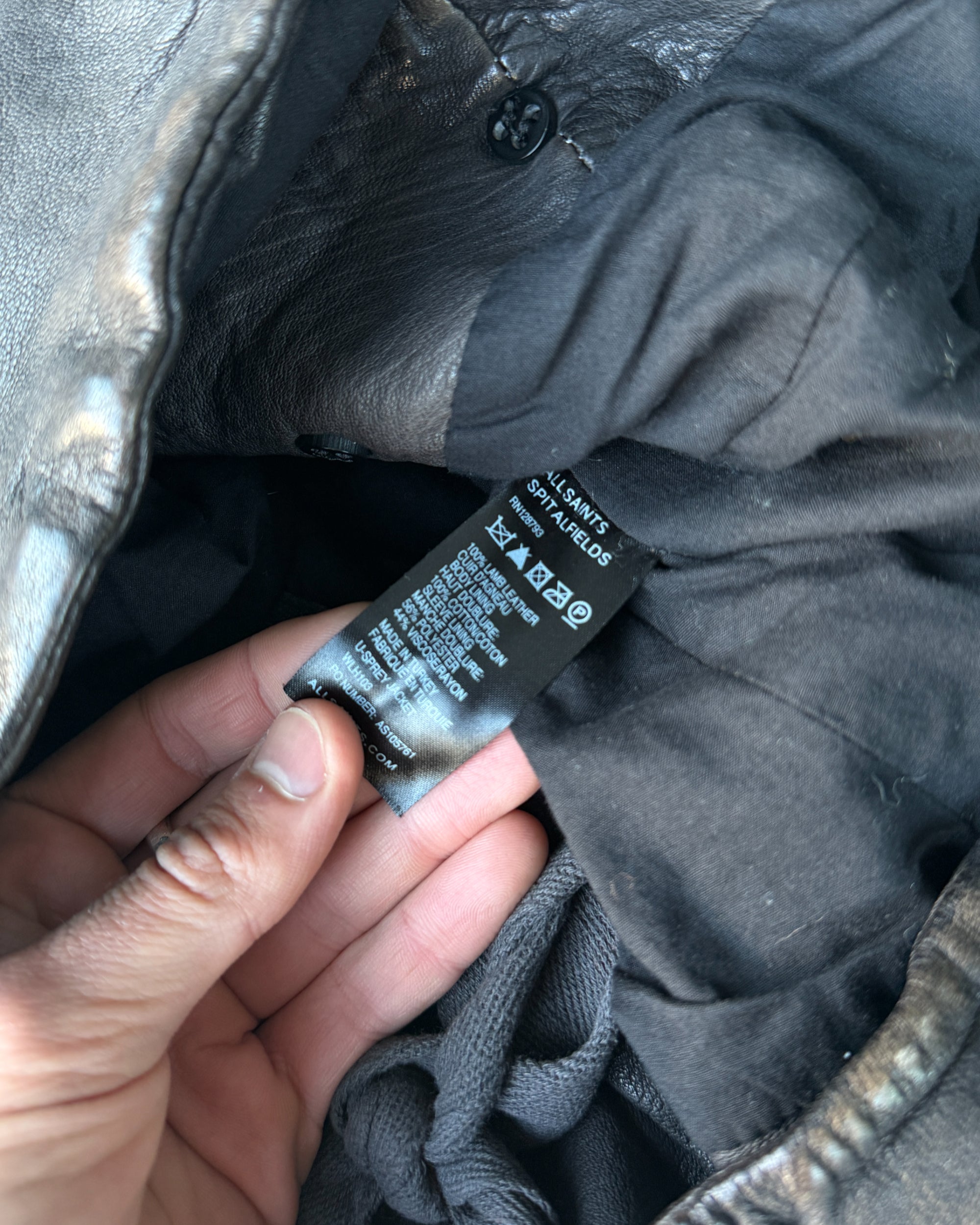 AllSaints 1990s Button-Up Leather Jacket – M-on a concrete background