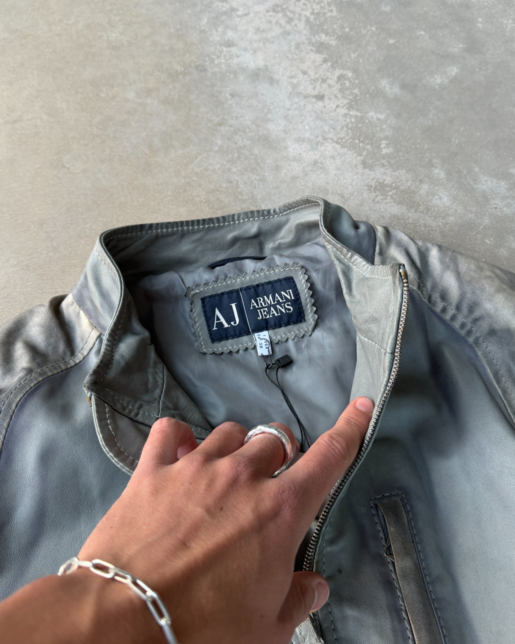 Armani Jeans Distressed Leather Jacket – L-on a concrete background