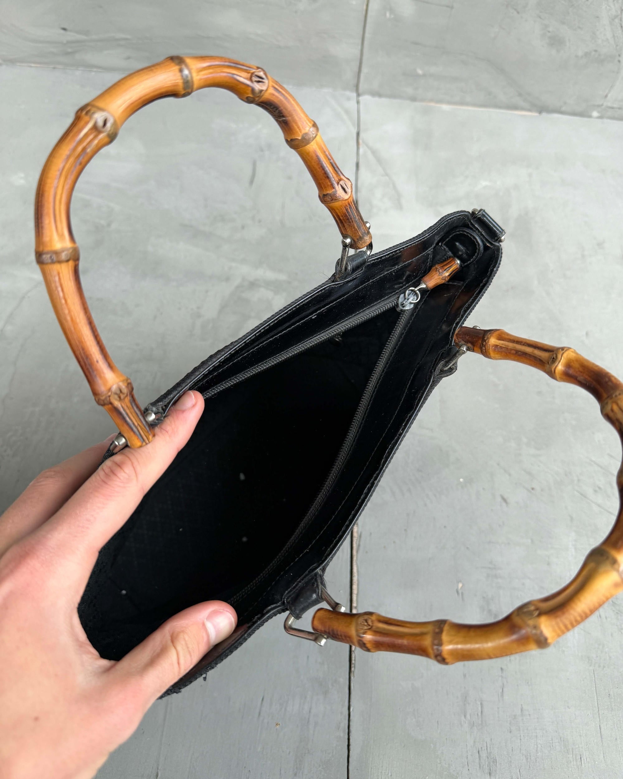 Gucci Bamboo Handle Handbag-on a concrete background