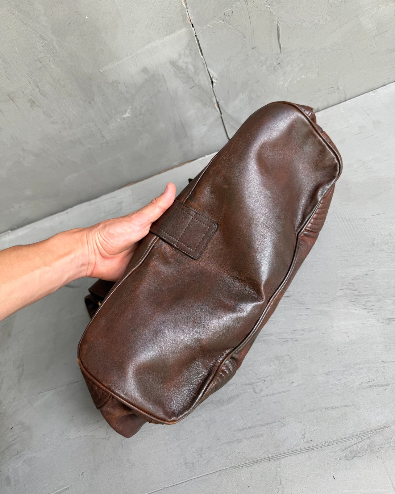 Alexander McQueen Faithful Multipocket Leather Shoulder Bag-on a concrete background