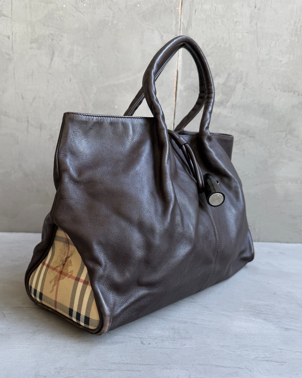 Burberry Dark Brown Leather Handbag-on a concrete background