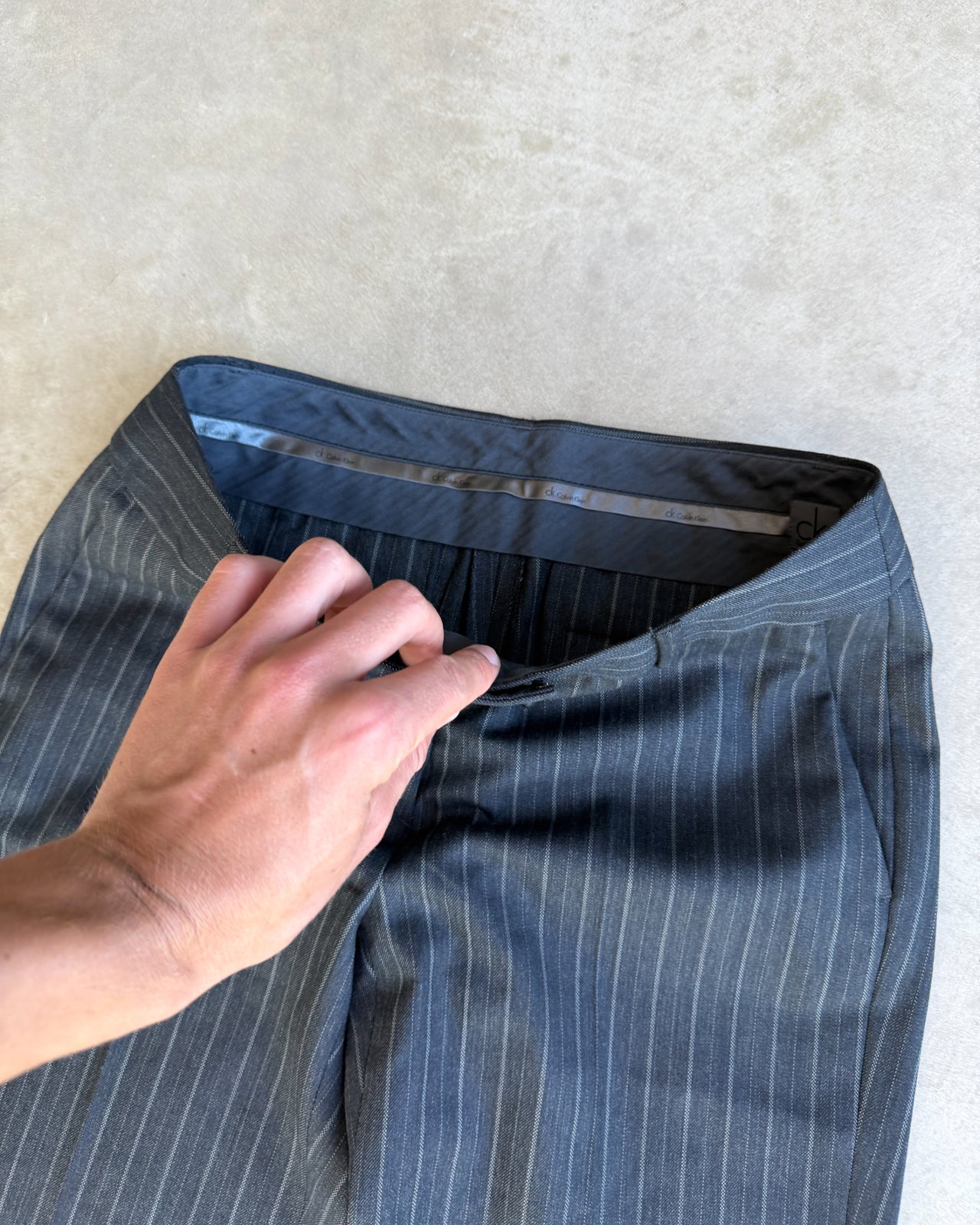 Calvin Klein Grey Pinstripe Suit – XS/S-on a concrete background