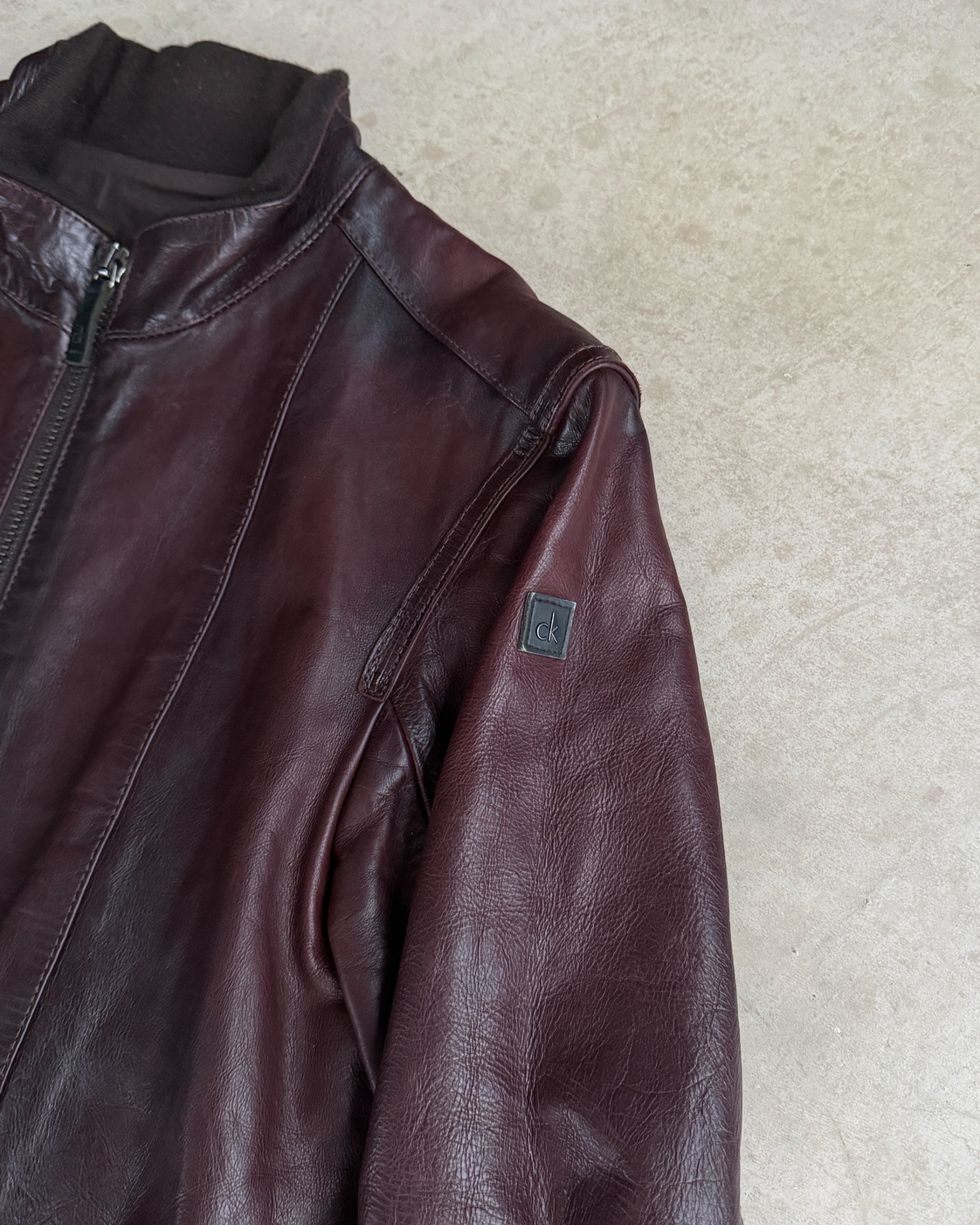 Calvin Klein Buckle Leather Jacket – M-on a concrete background