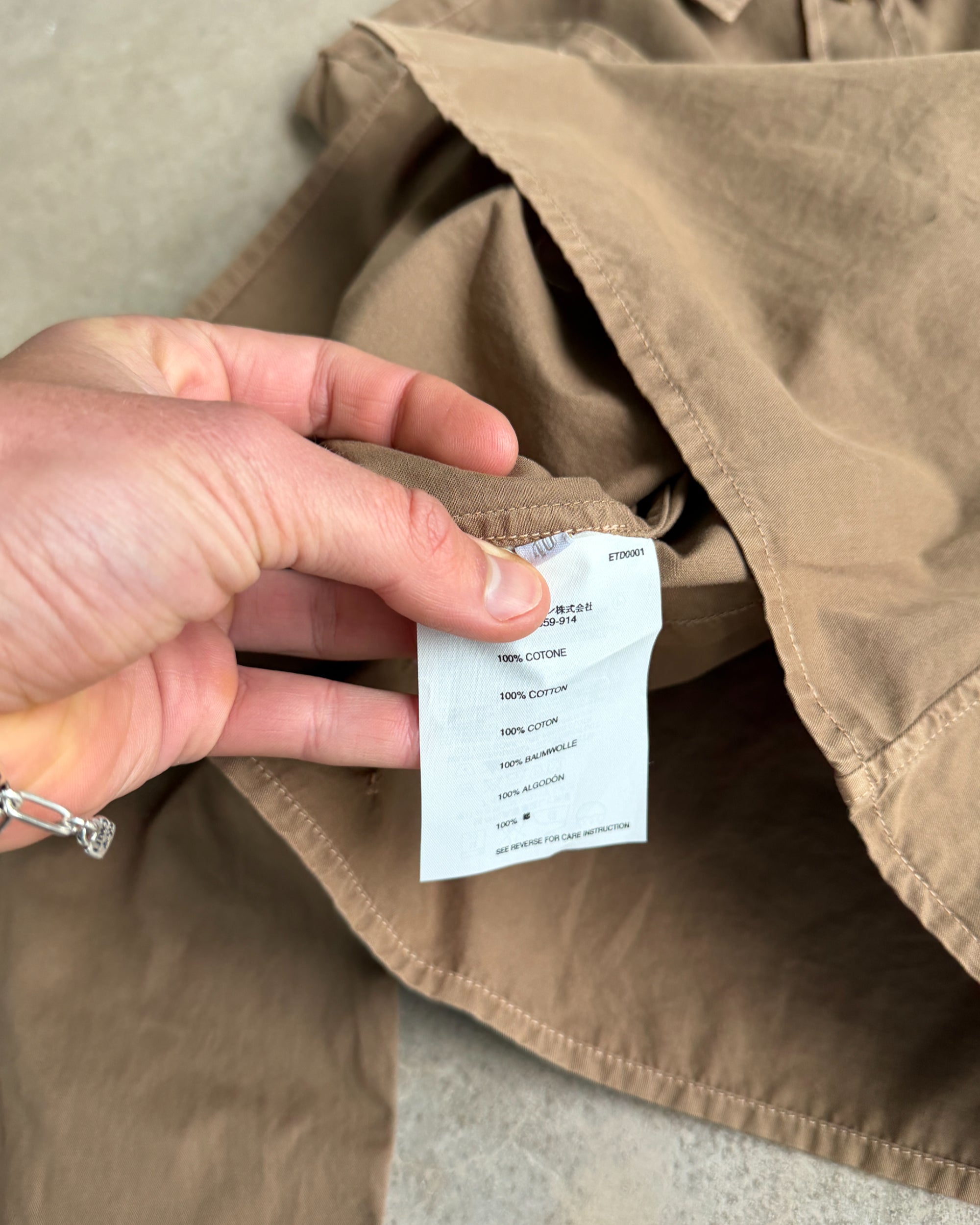 Prada Brown Cotton Shirt – S-on a concrete background