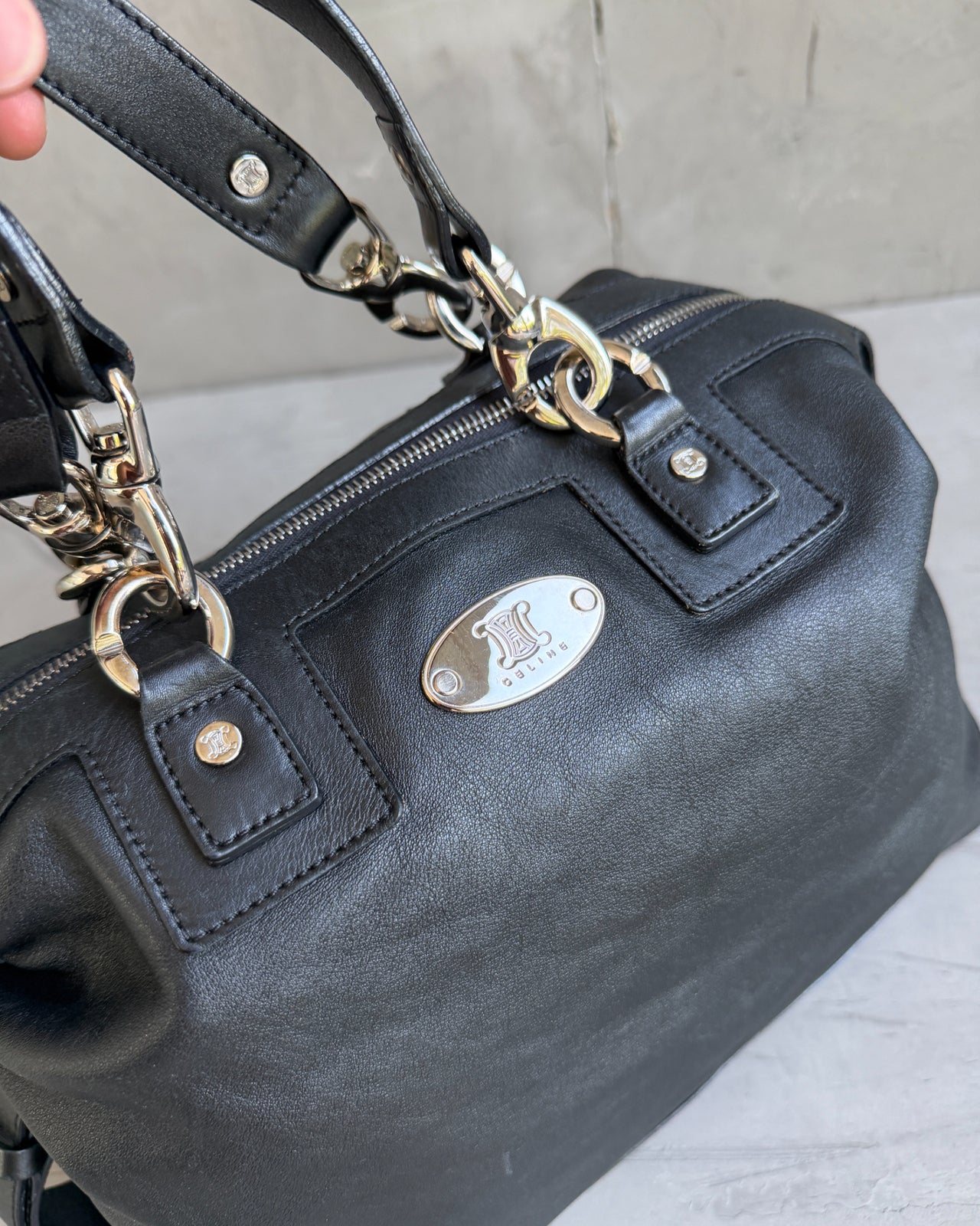 Celine Black Leather Handbag-on a concrete background