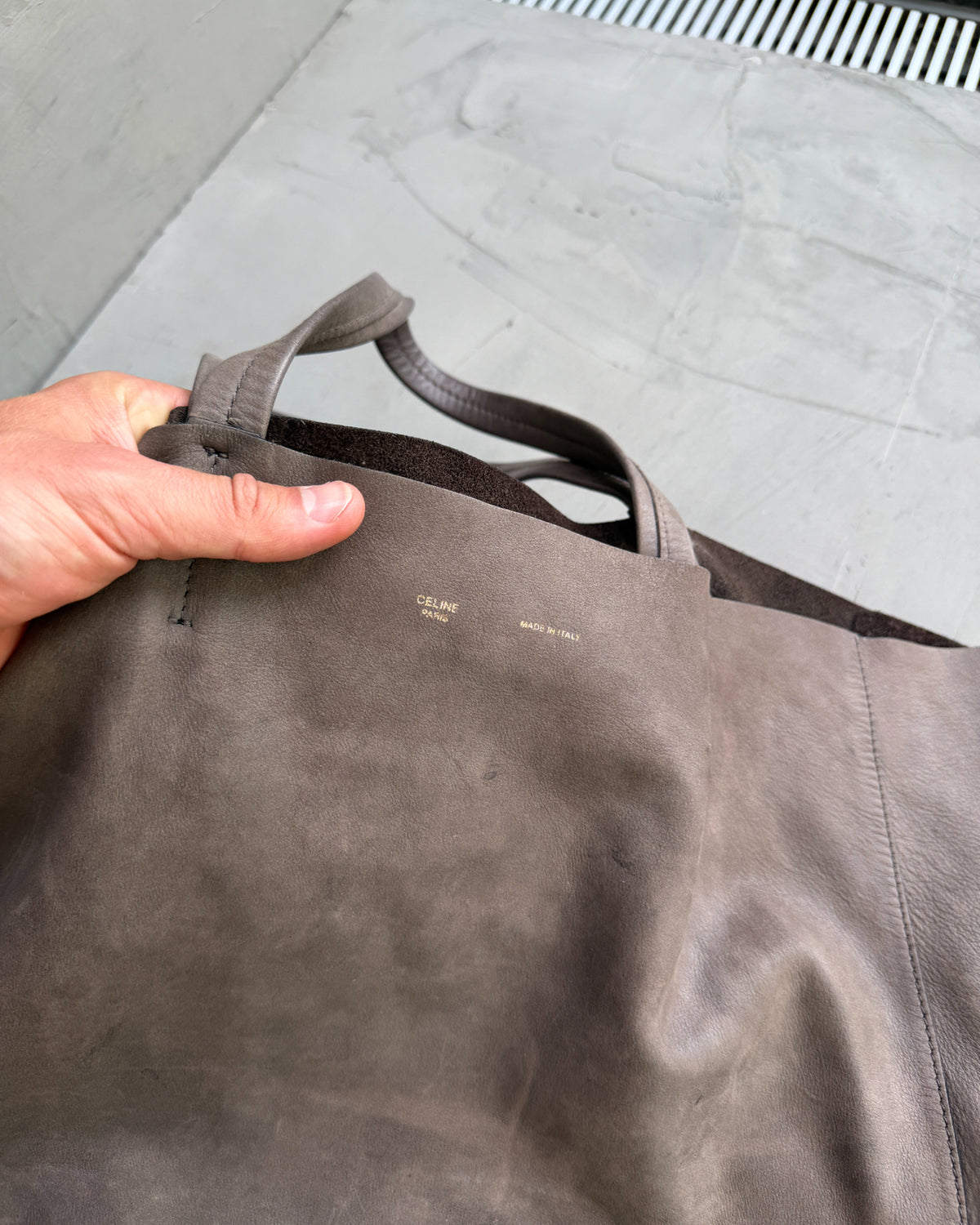 Celine Brown Leather Tote Bag-on a concrete background