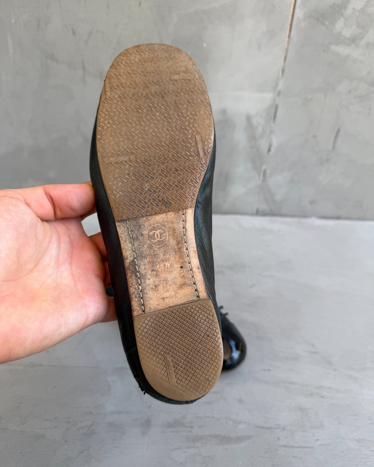 Chanel Black Ballet Flat – EU 38-on a concrete background