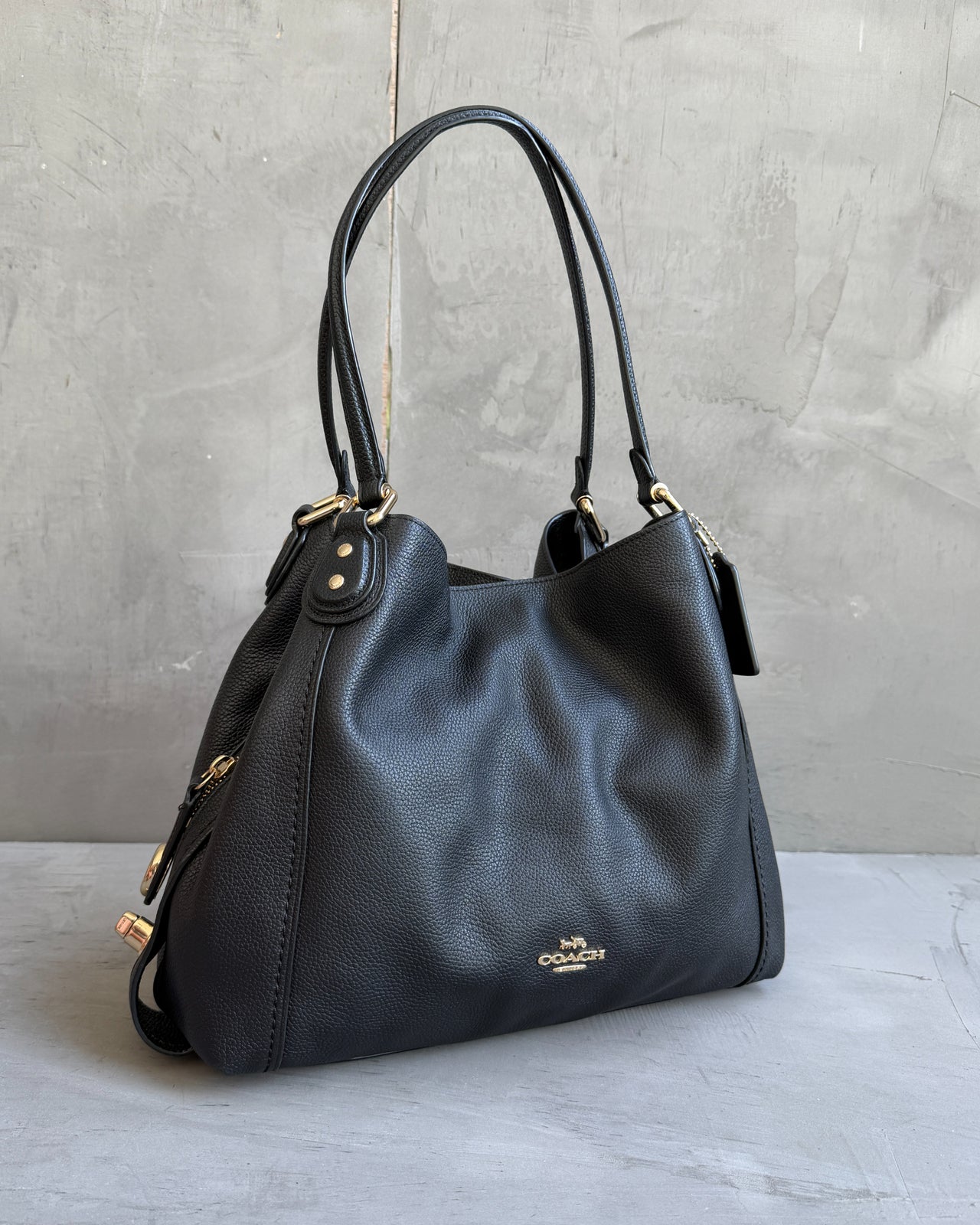 Coach Black Leather Bag-on a concrete background