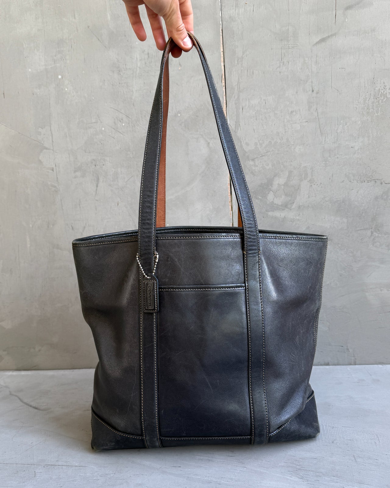 Coach Black Leather Tote Shoulder Bag-on a concrete background