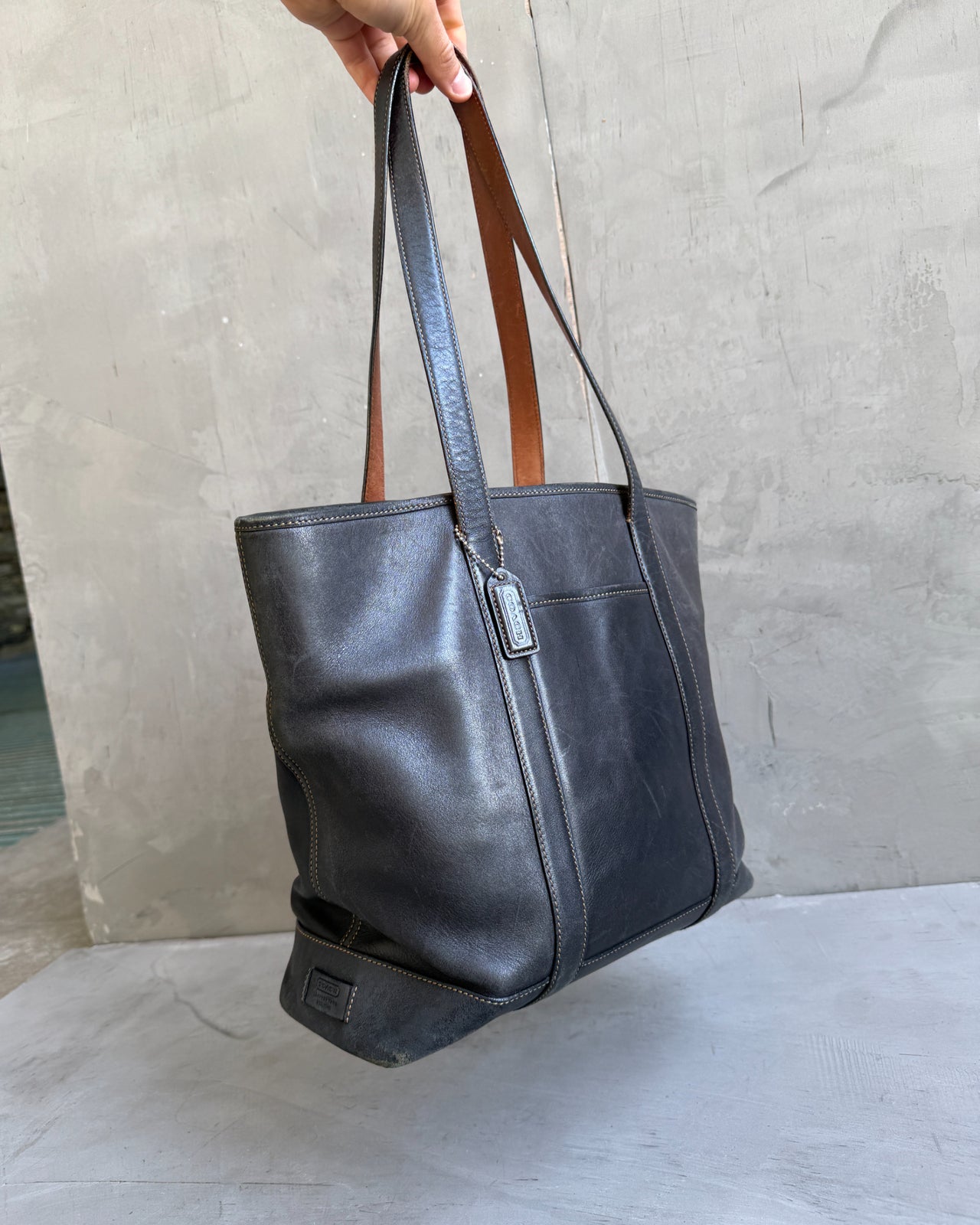 Coach Black Leather Tote Shoulder Bag-on a concrete background