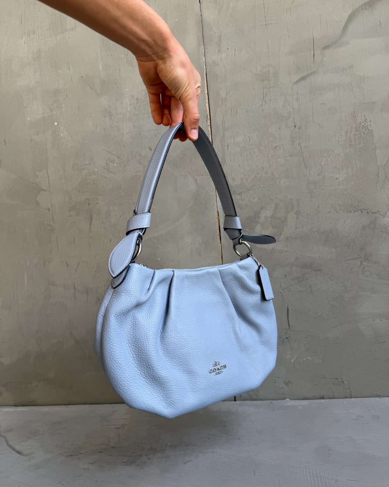 Coach Lilac Blue Leather Shoulder Bag-on a concrete background