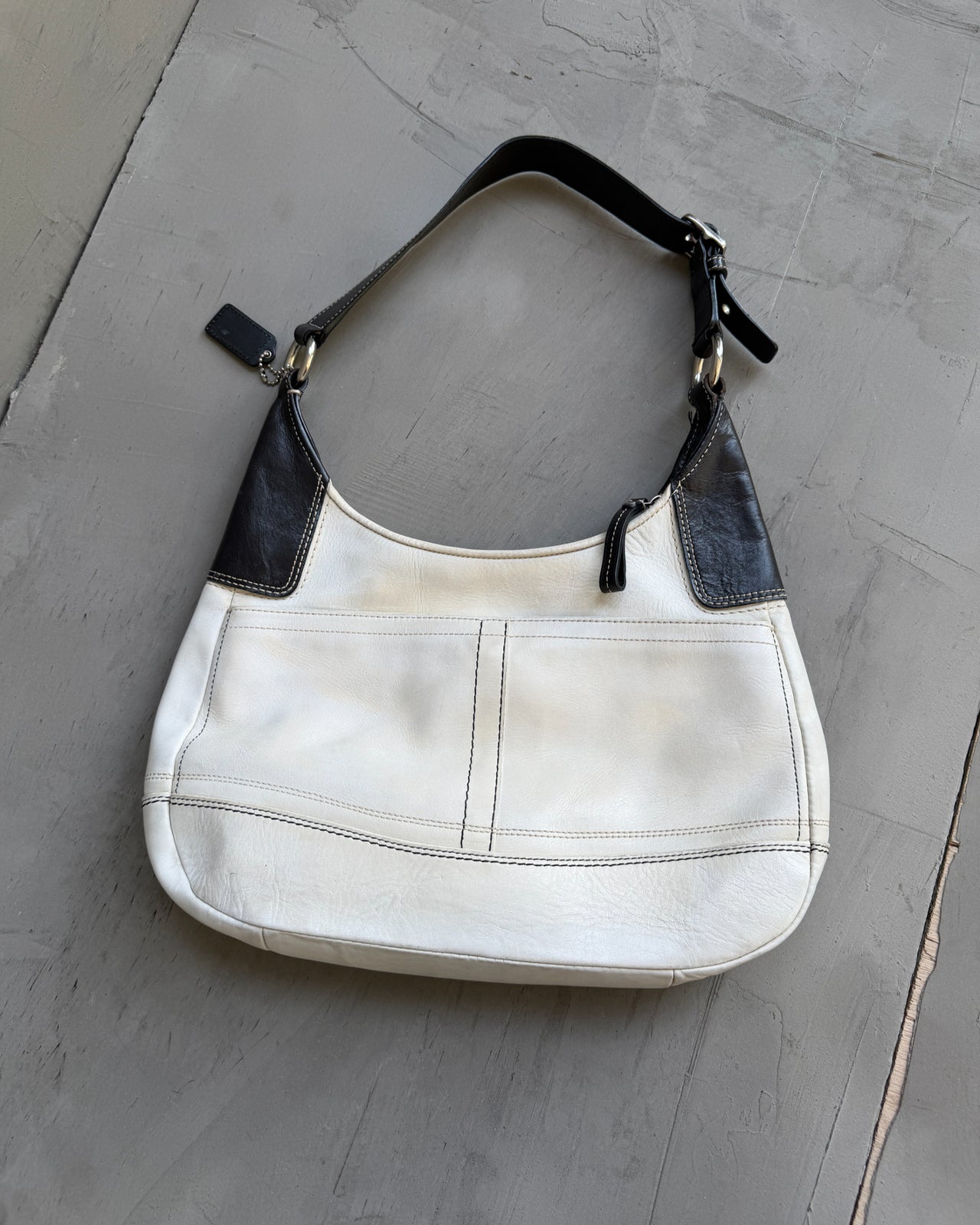 Coach Two Tone Leather Shoulder Bag-on a concrete background