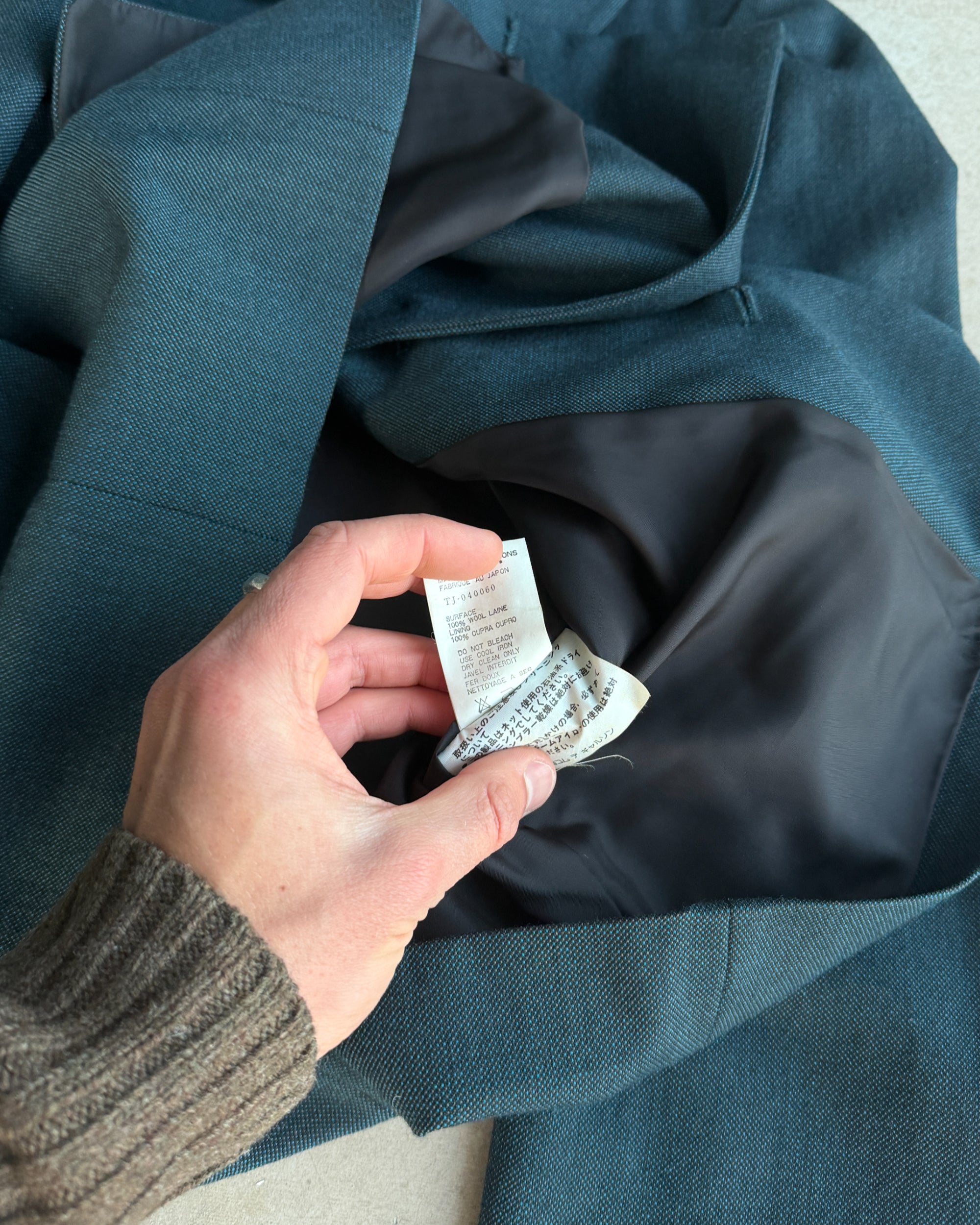 Comme des Garçons Tricot FW96 Wool Jacket – M-on a concrete background