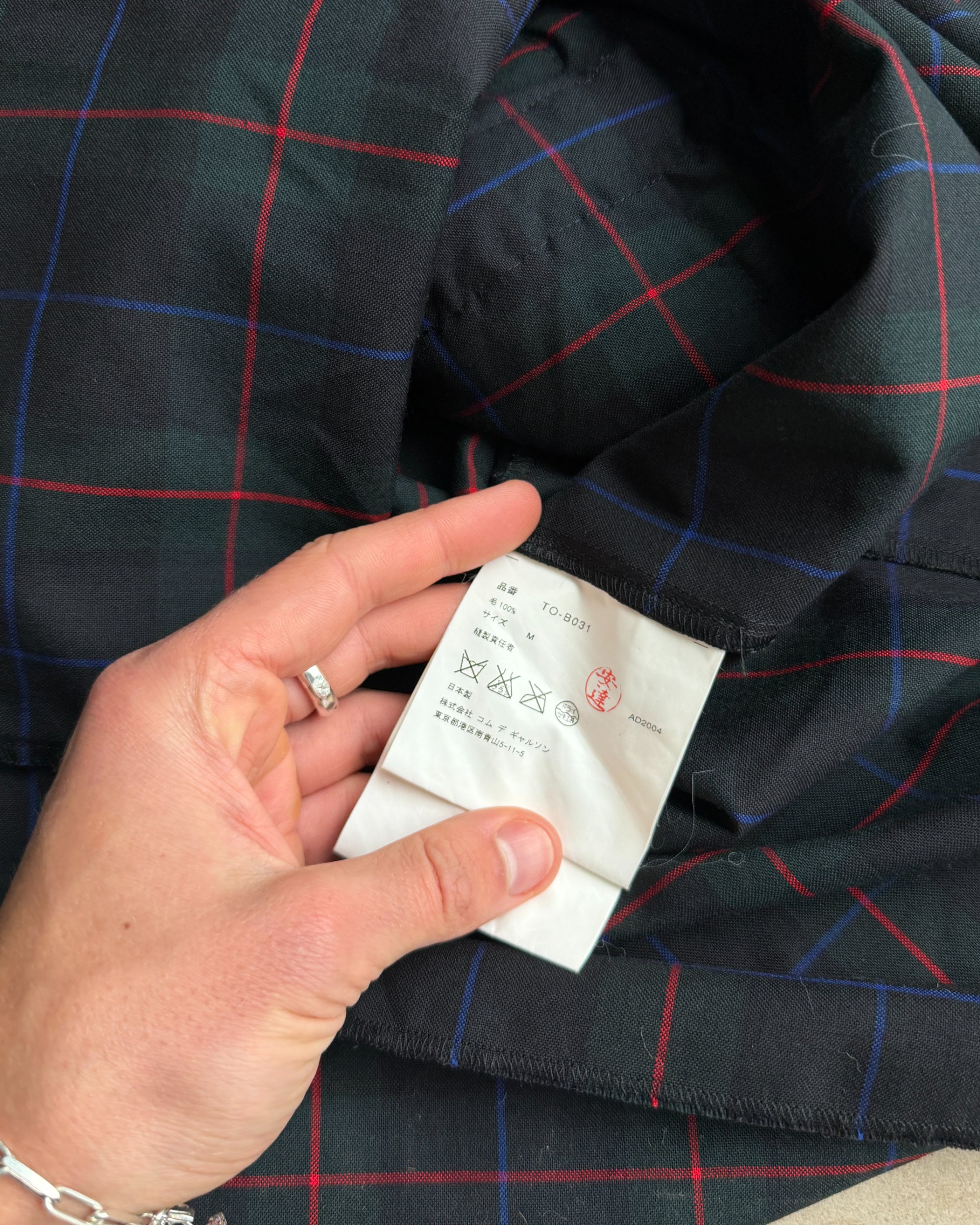 Comme des Garçons Tricot AW04 Checkered Short Sleeve Shirt – M-on a concrete background