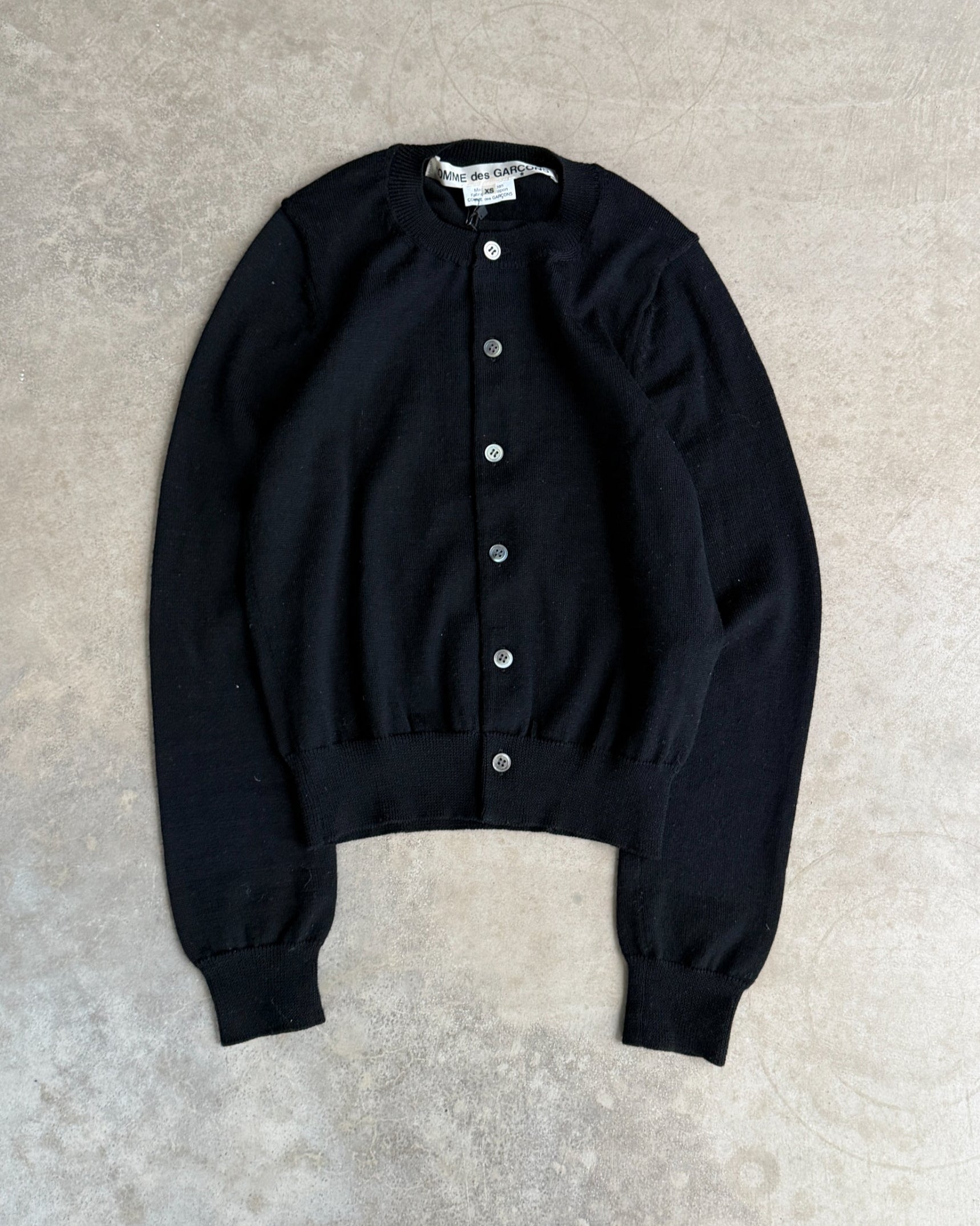 Comme des Garçons 2015 Wool Cardigan – XS-on a concrete background