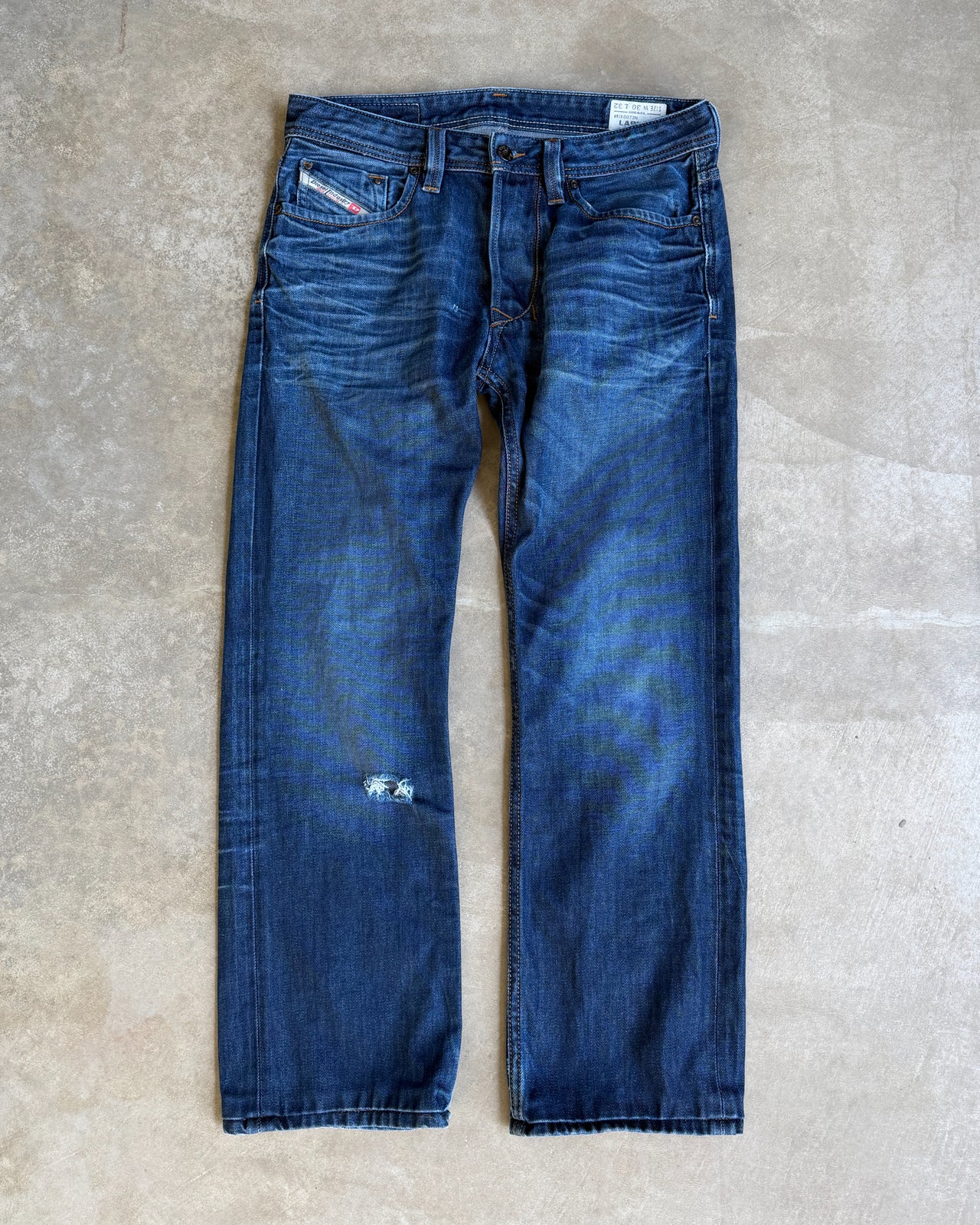 Diesel Mid Blue Distressed Straight Leg Jeans – W30/L28-on a concrete background