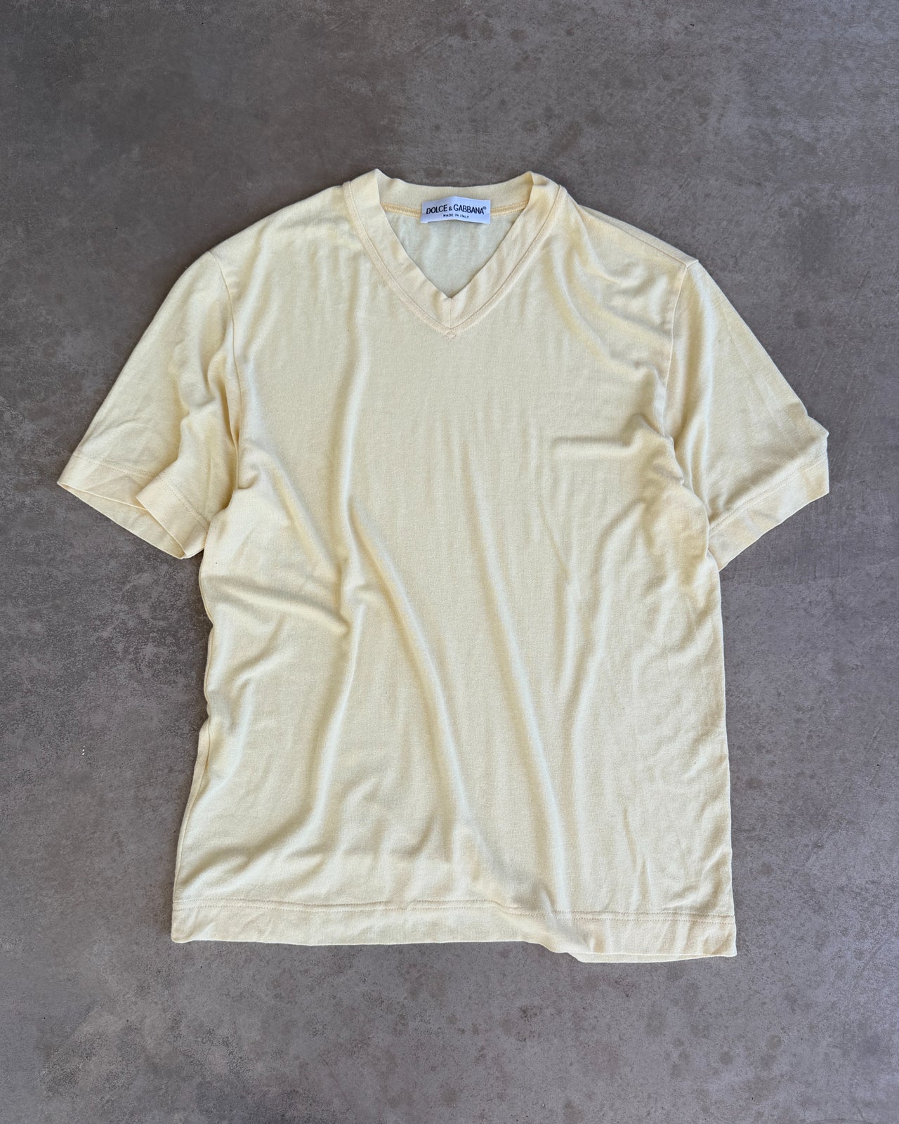 Dolce & Gabbana Yellow Viscose Semi Sheer V Neck T-Shirt – L-on a concrete background