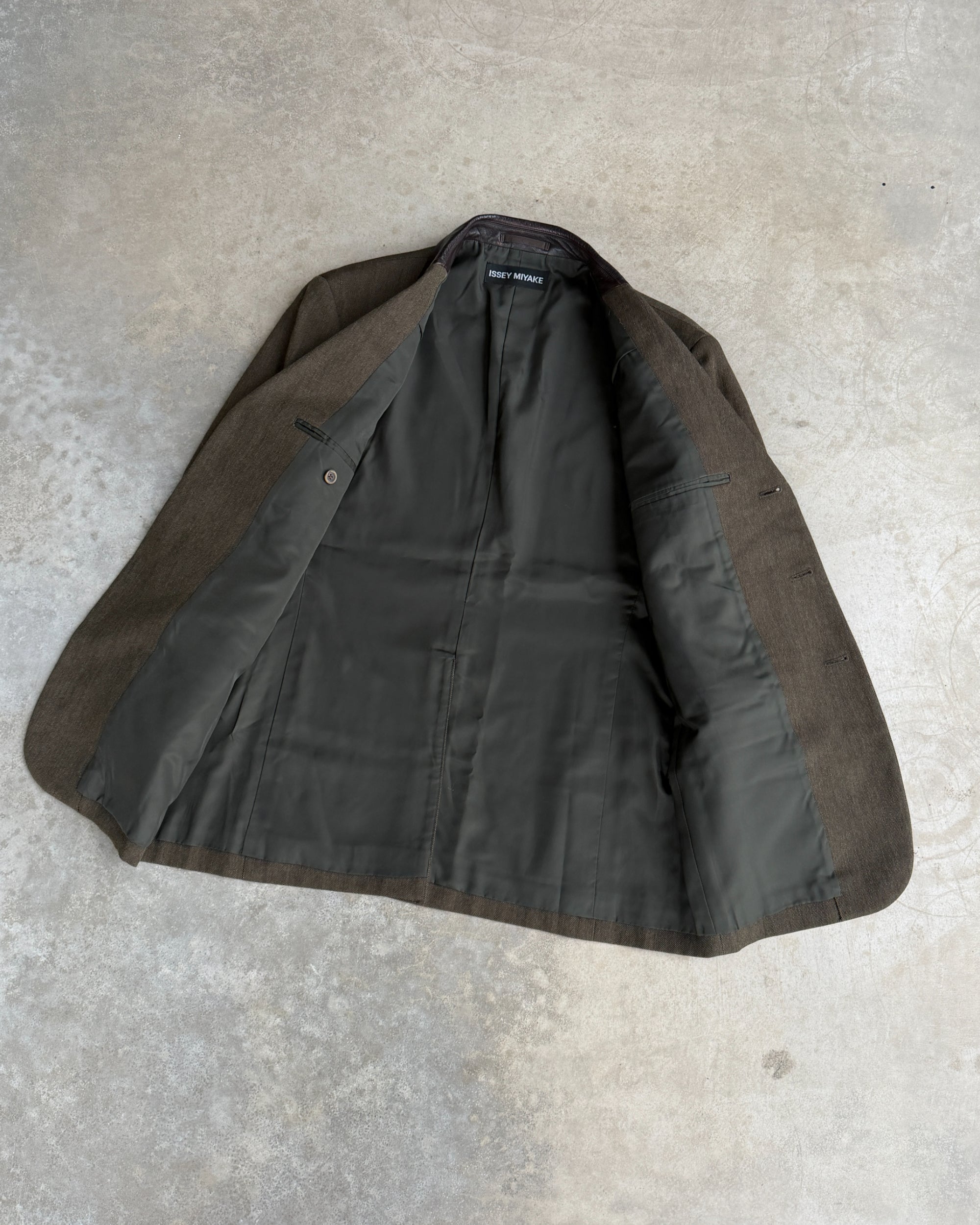 Issey Miyake AW2013 Wool Blazer with Leather Collar – M-on a concrete background