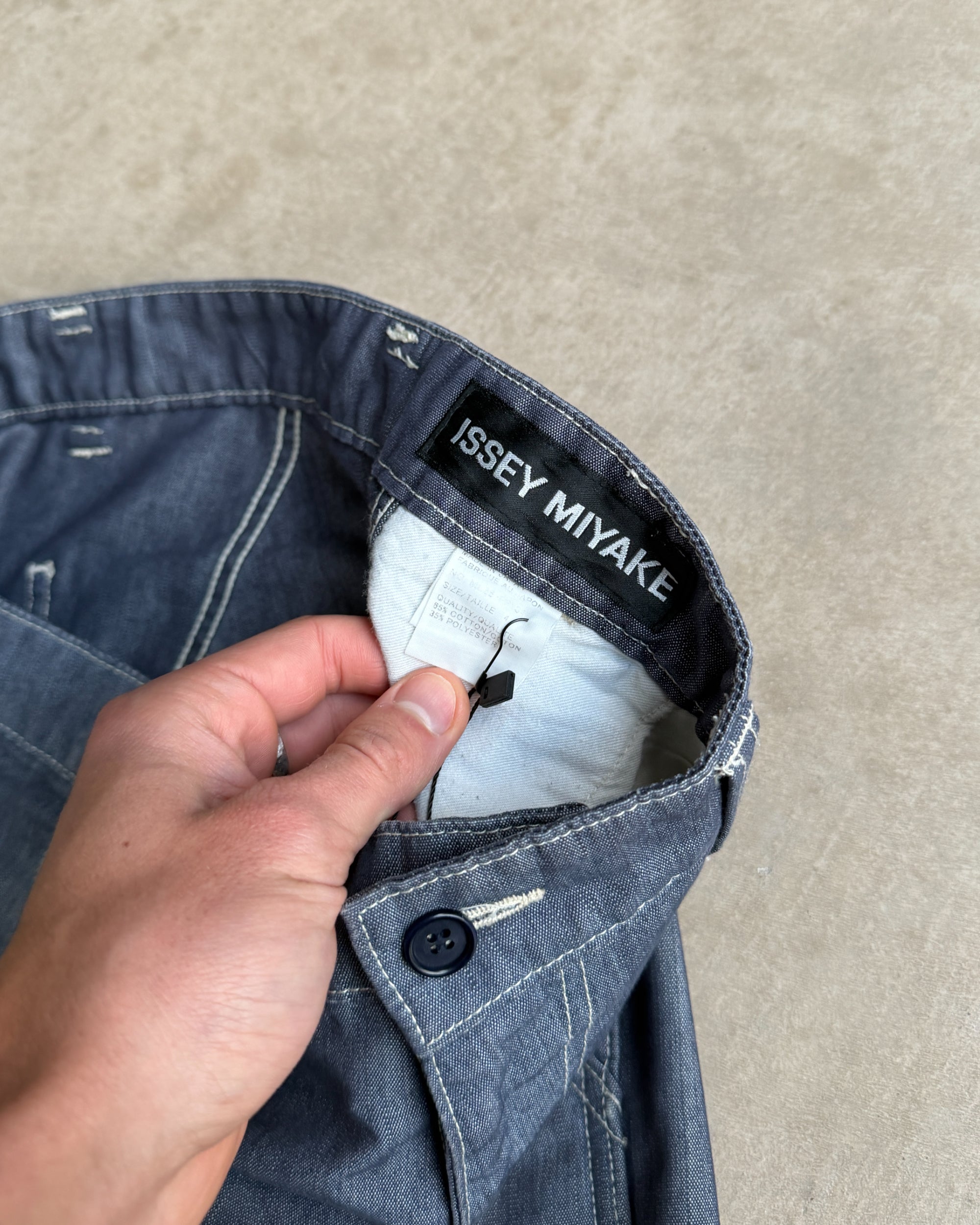 Issey Miyake AW2003 Wide Leg Chambray Denim Trousers – W33–34-on a concrete background