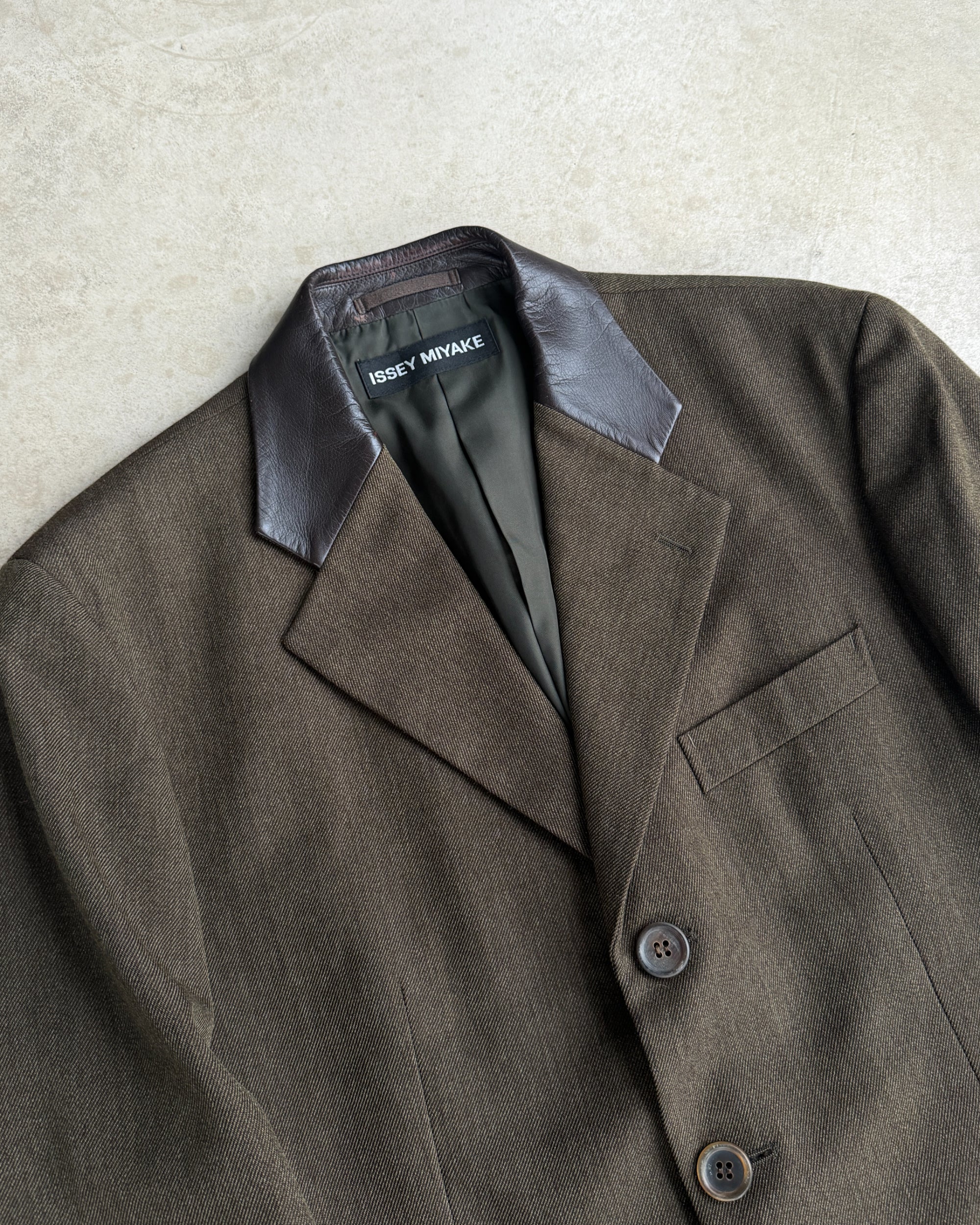 Issey Miyake AW2013 Wool Blazer with Leather Collar – M-on a concrete background