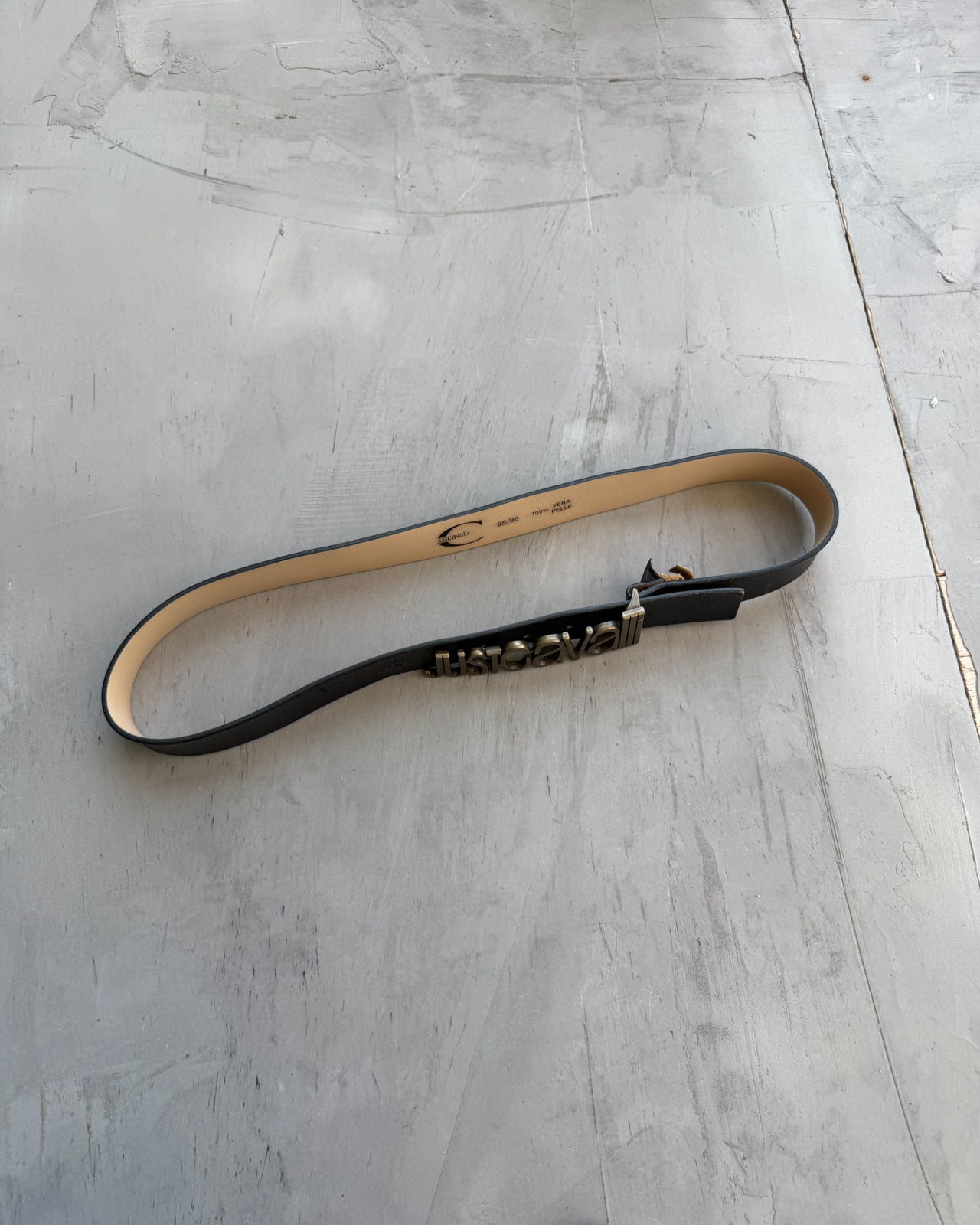 Just Cavalli Black Leather Belt-on a concrete background