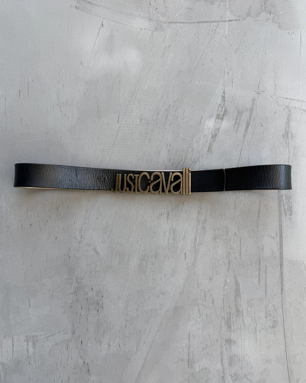 Just Cavalli Black Leather Belt-on a concrete background
